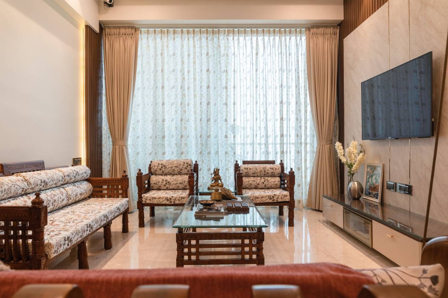 Living Room Design with Print Upholstered Sofas and Marble Backsplash TV Unit