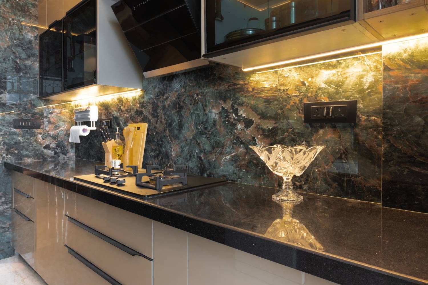 Parallel Kitchen Design with Black Marble Patterned Backsplash and Under Cabinet Lighting