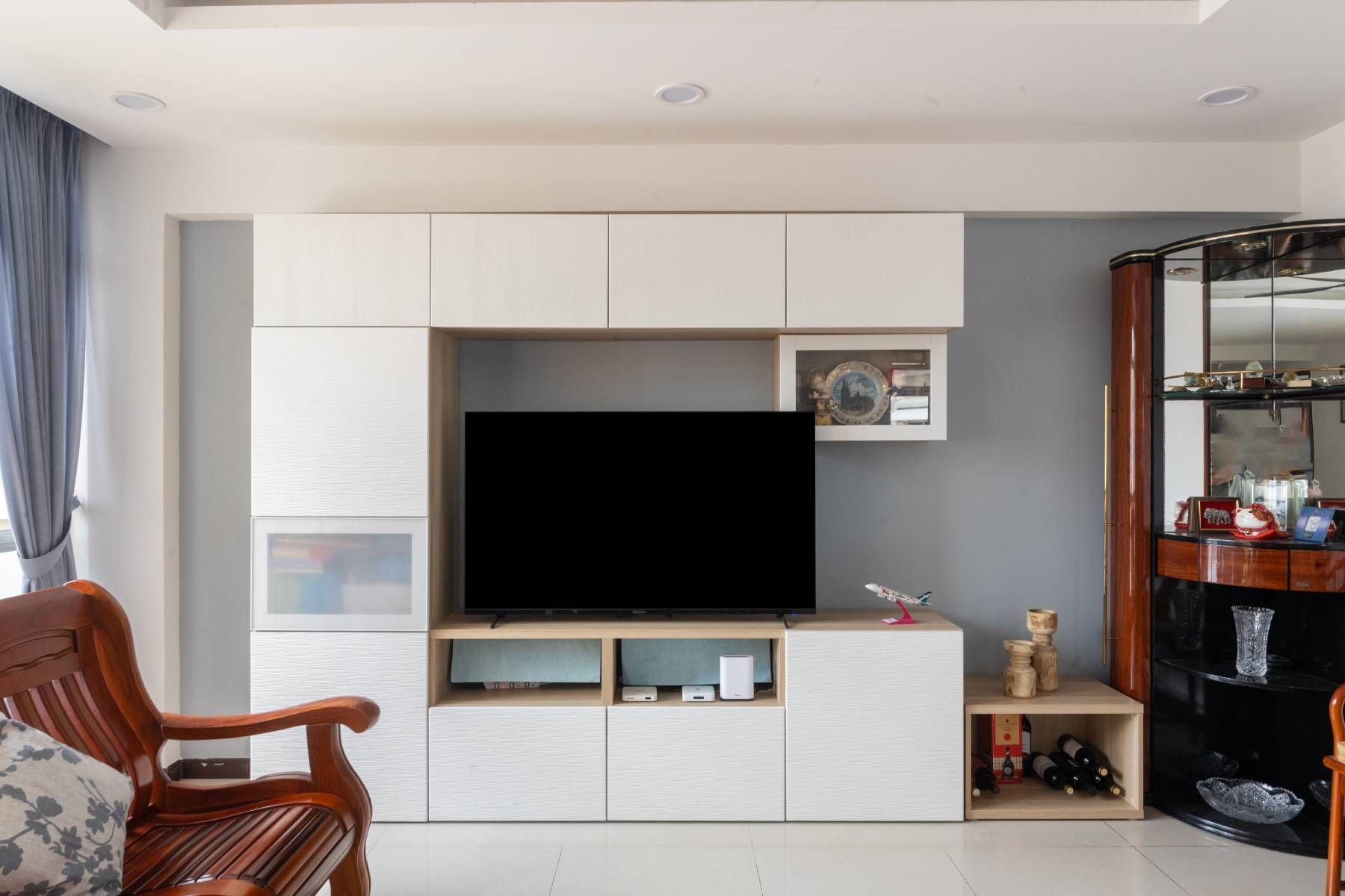 Minimalist Design With A White TV Unit And Grey Paint For The Back Wall