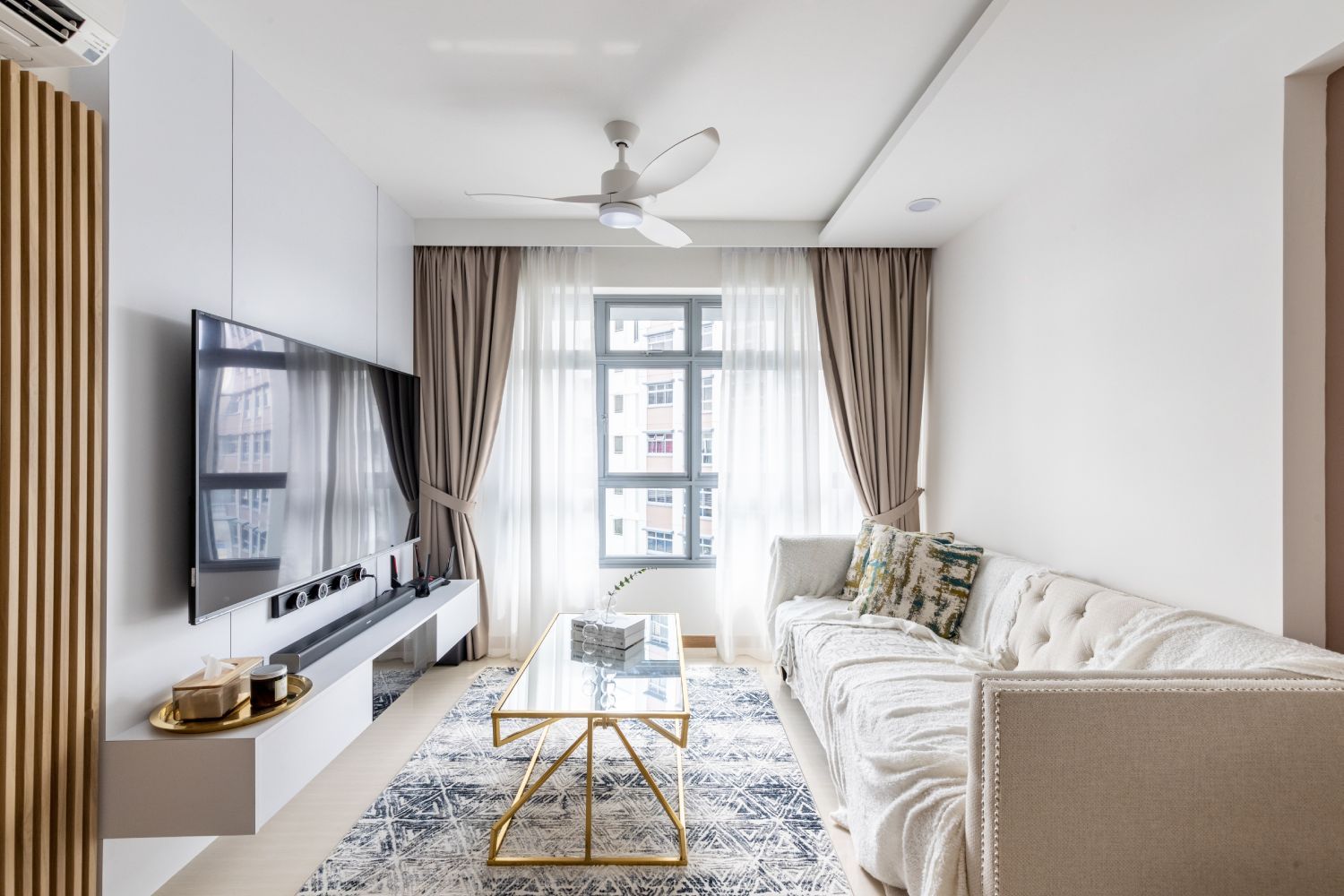 Spacious Living Room Design With Cream-Toned Sofa And Glass Coffee ...