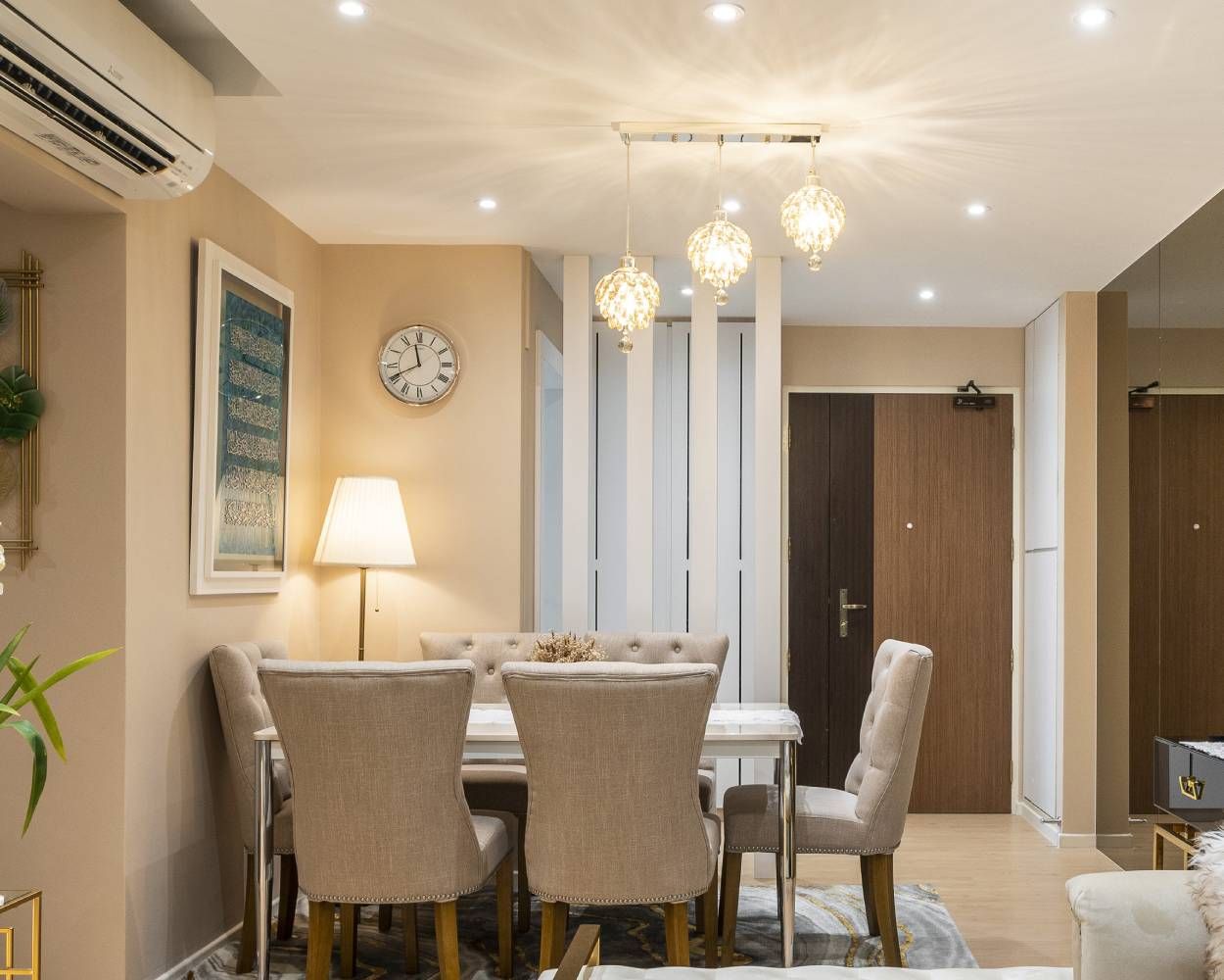 Contemporary Beige And White 6-Seater Dining Room Design With Ornamental Drop-Down Lights