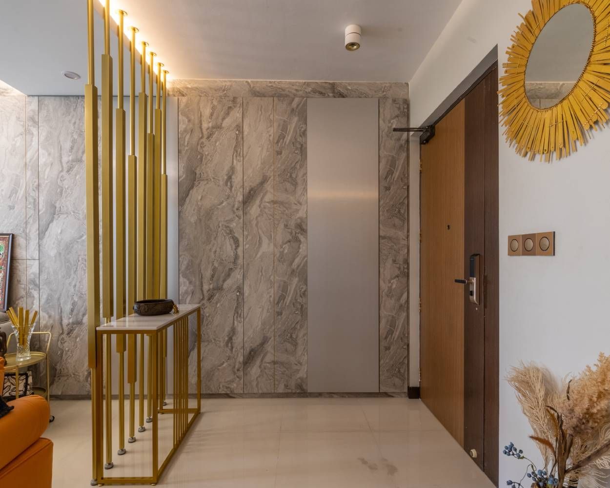 Contemporary Foyer Design With White Console And Vertical Gold Panels
