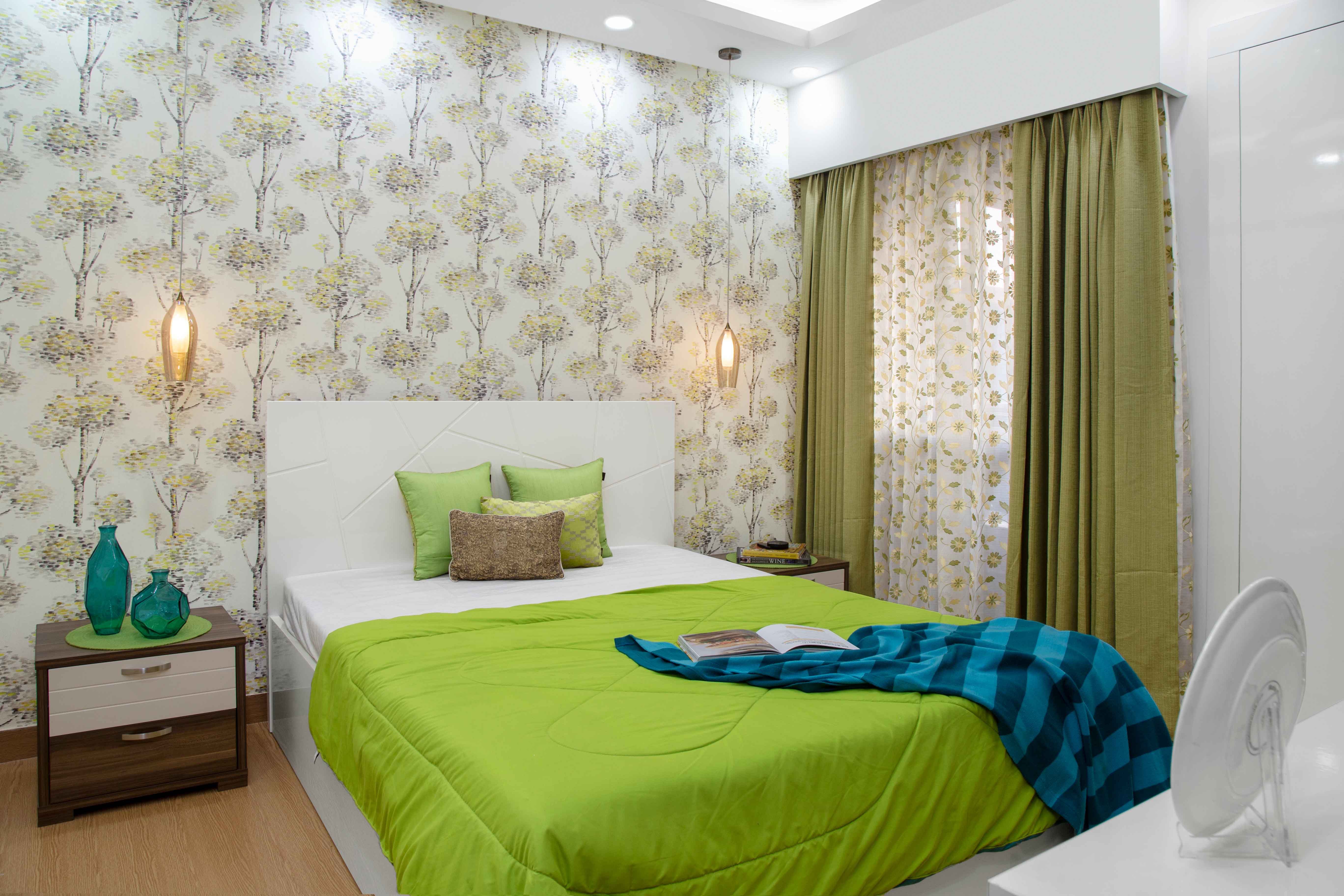 Tropical Guest Room Design With Green Upholstery And Nature-Themed Wallpaper