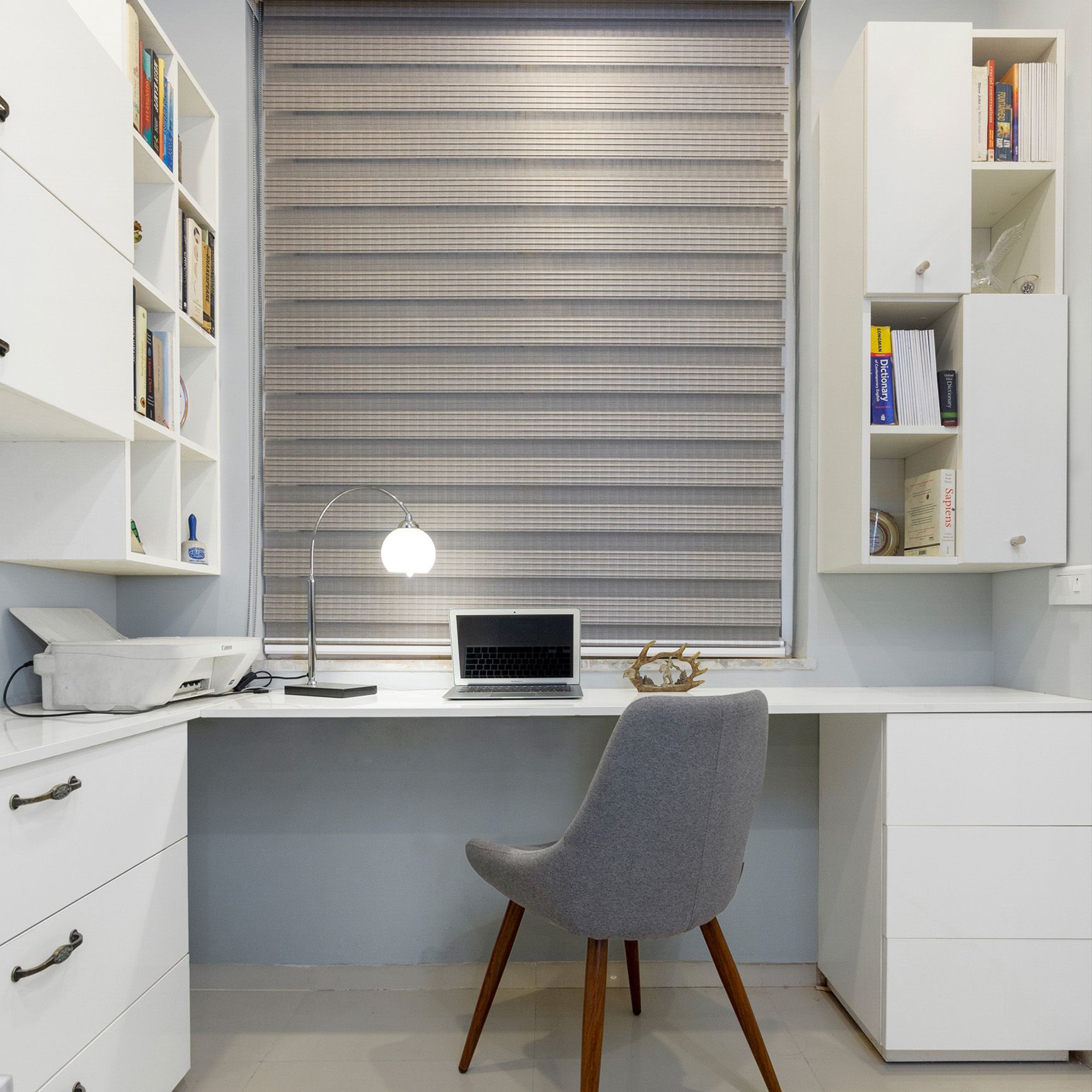 Modern Frosty White Home Office Design With Overhead Cabinets