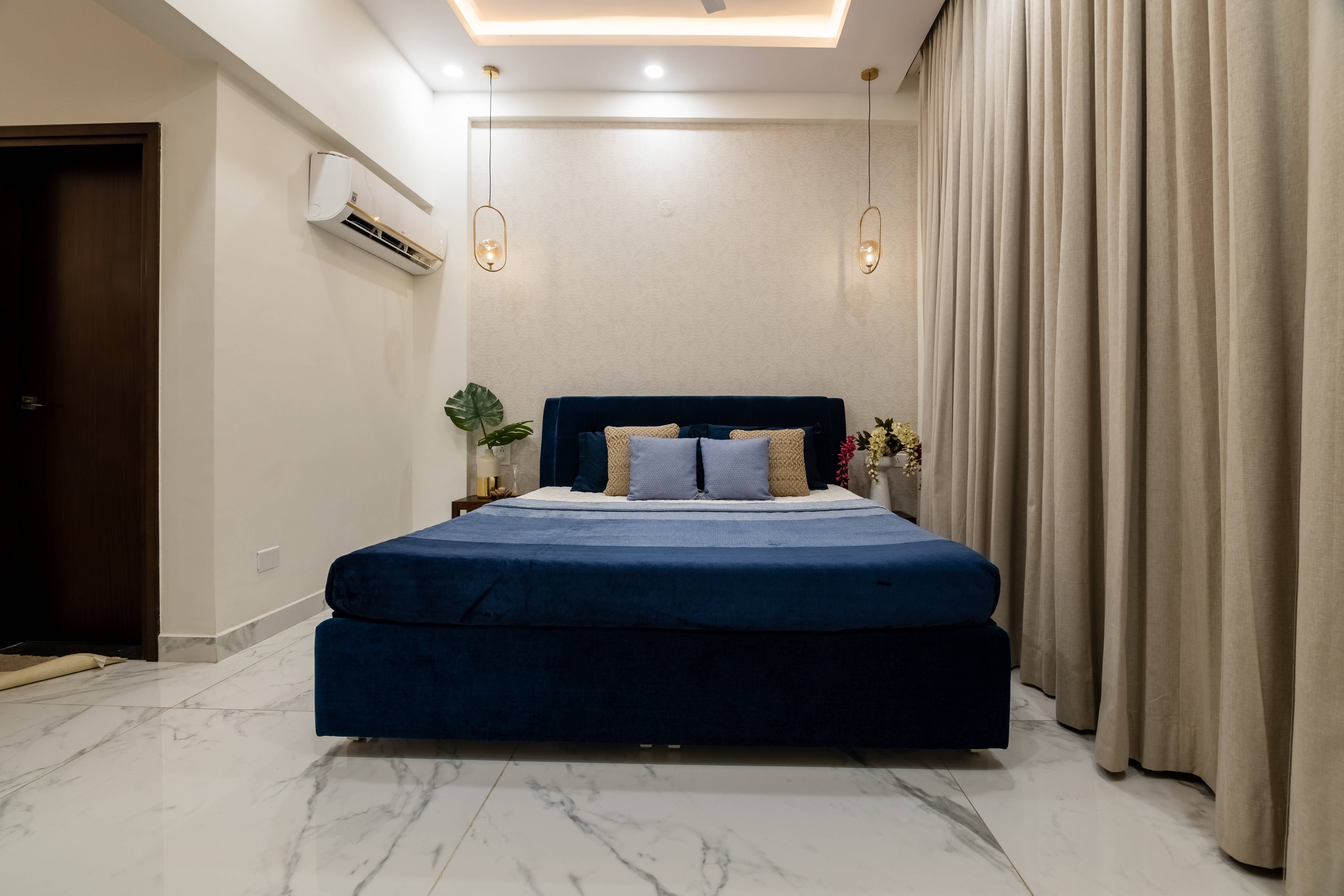 Spacious Guest Bedroom Design With Navy Blue Bed | Livspace