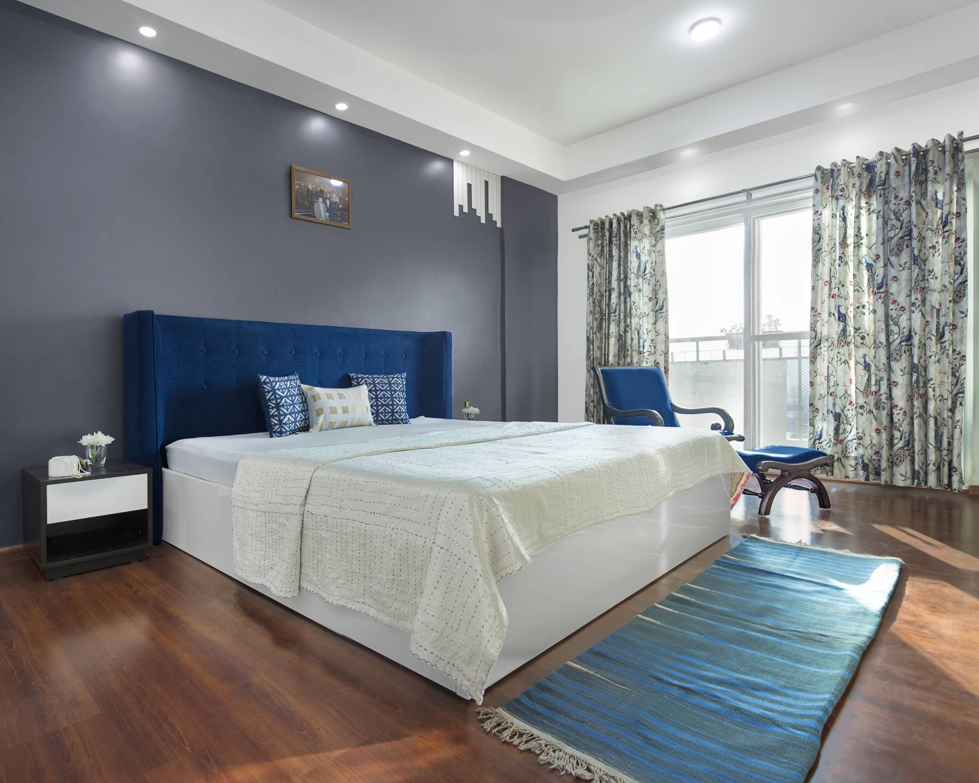 Modern Guest Room Design With Blue Accent Chair And Pouffe