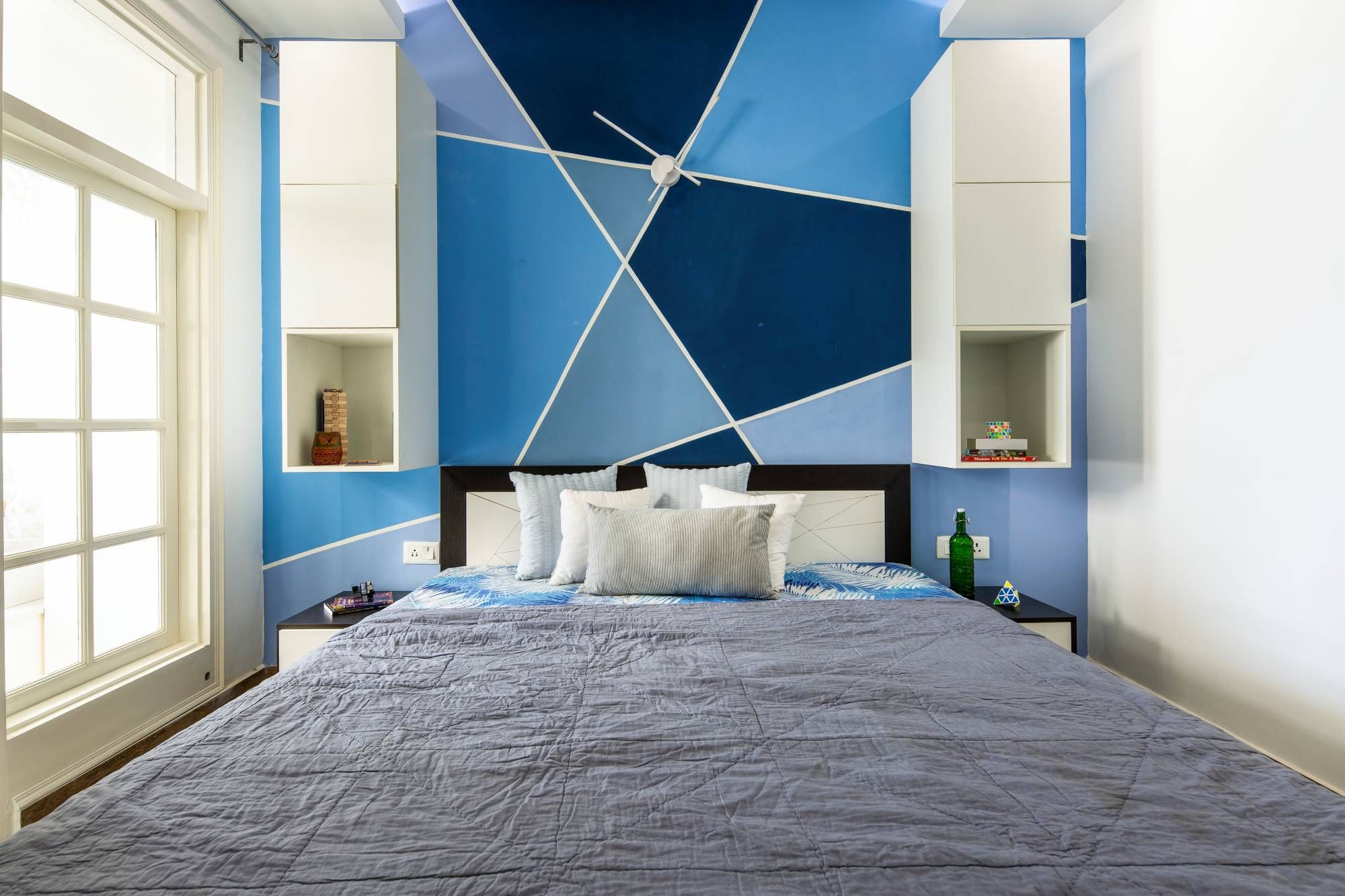 Modern Kids Room Design With A Double Bed And White Wall Storage Units