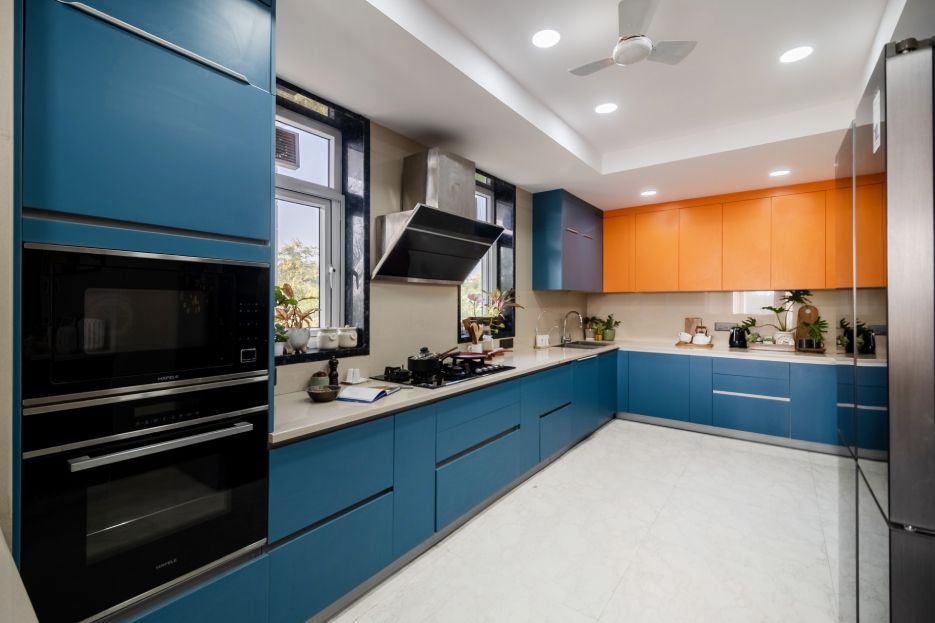 Modern U-Shaped Kitchen Design With Blue And Orange Storage Units