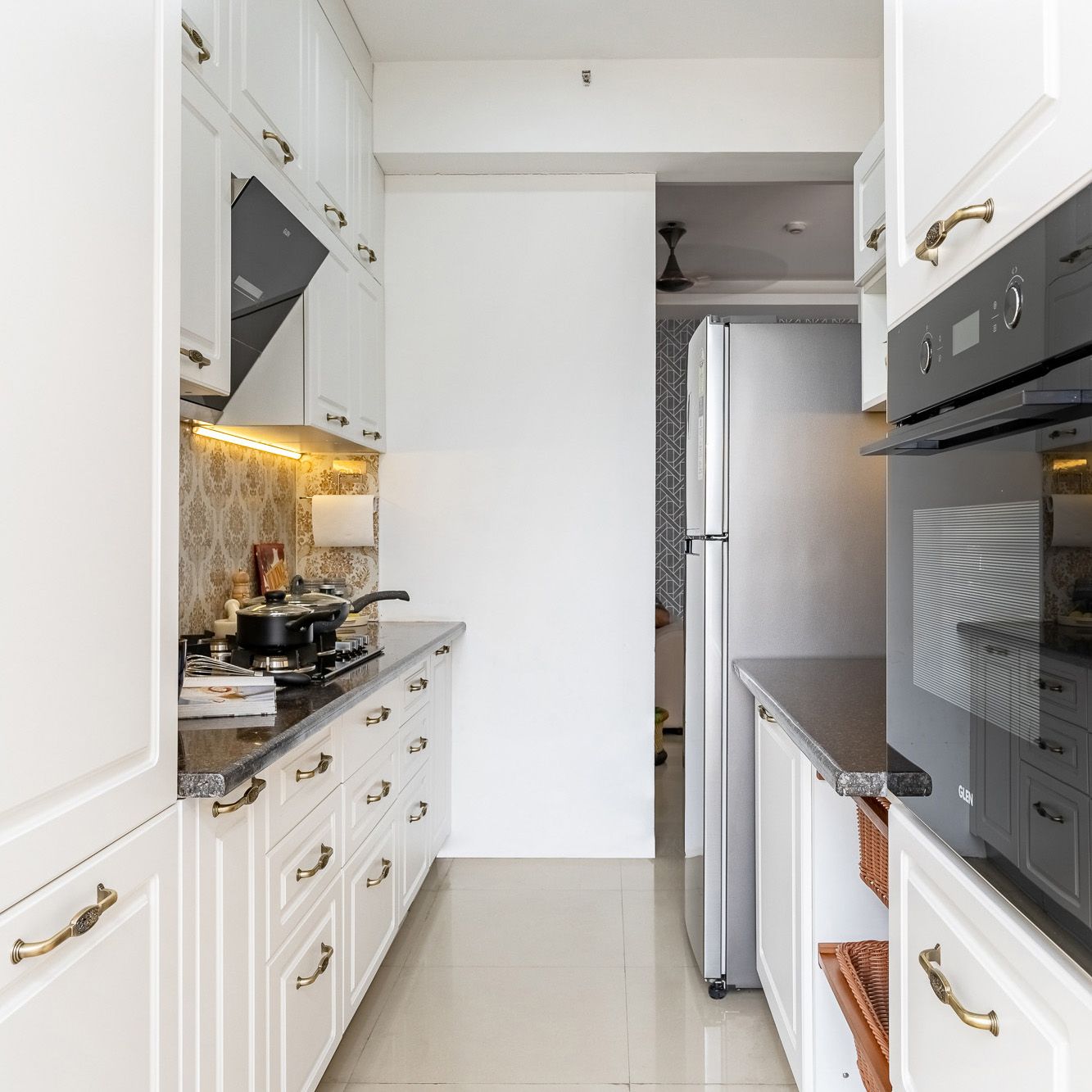 Mid-Century Parallel Kitchen Design With White Closed Storage Cabinets