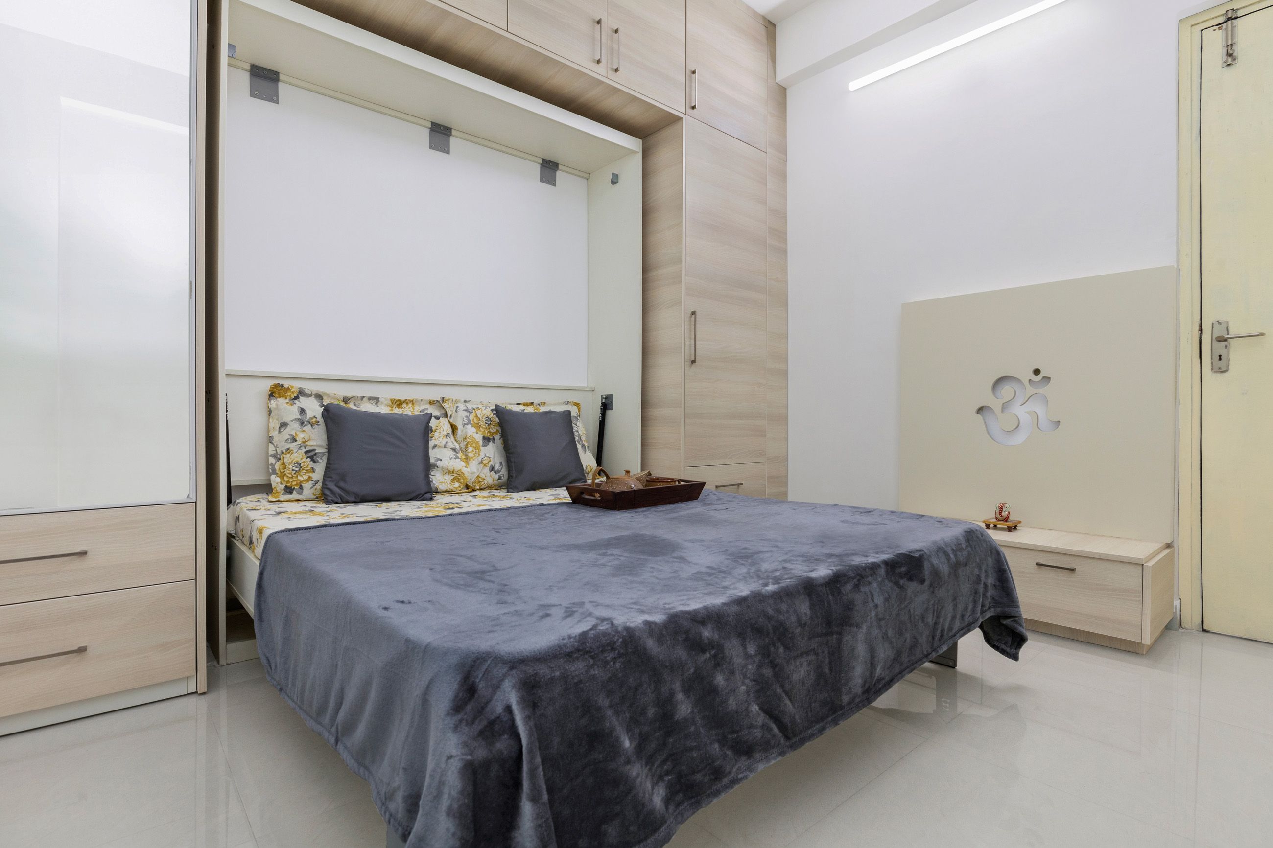 Minimal Guest Room Design With Grey Pull-Out Bed And Integrated Mandir Unit