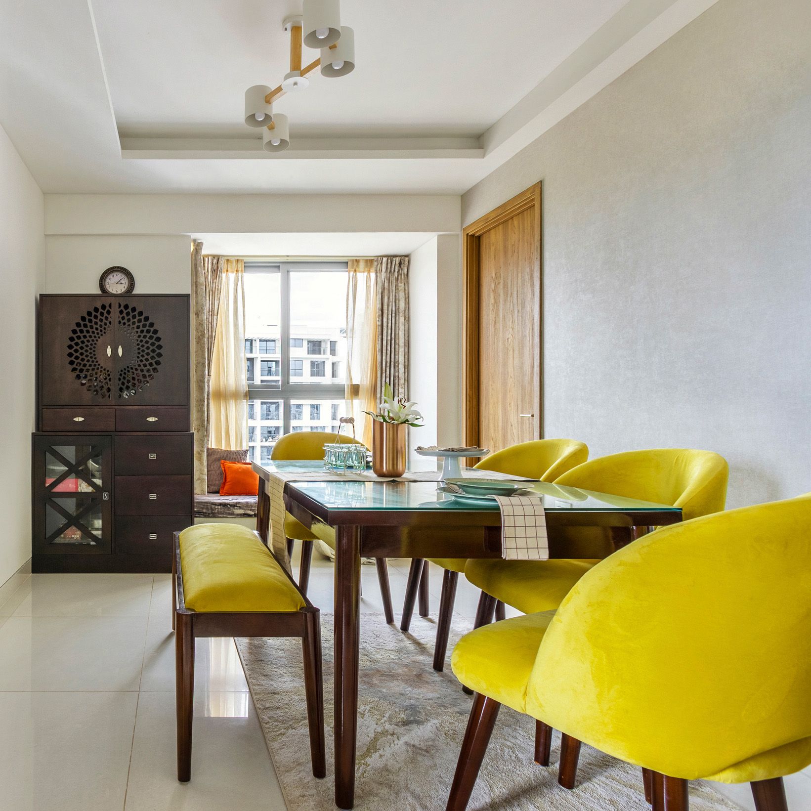 Modern 2-BHK Flat Design In Bangalore With 4-Seater Yellow And Wood Dining Room Design