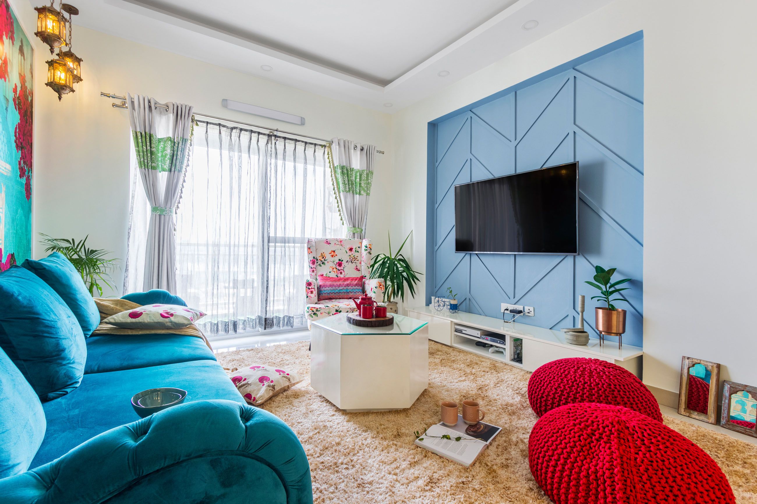 Contemporary 2-BHK Flat Design In Bangalore With Blue And Pink Living Room Design And Bougainvillea Wallpaper