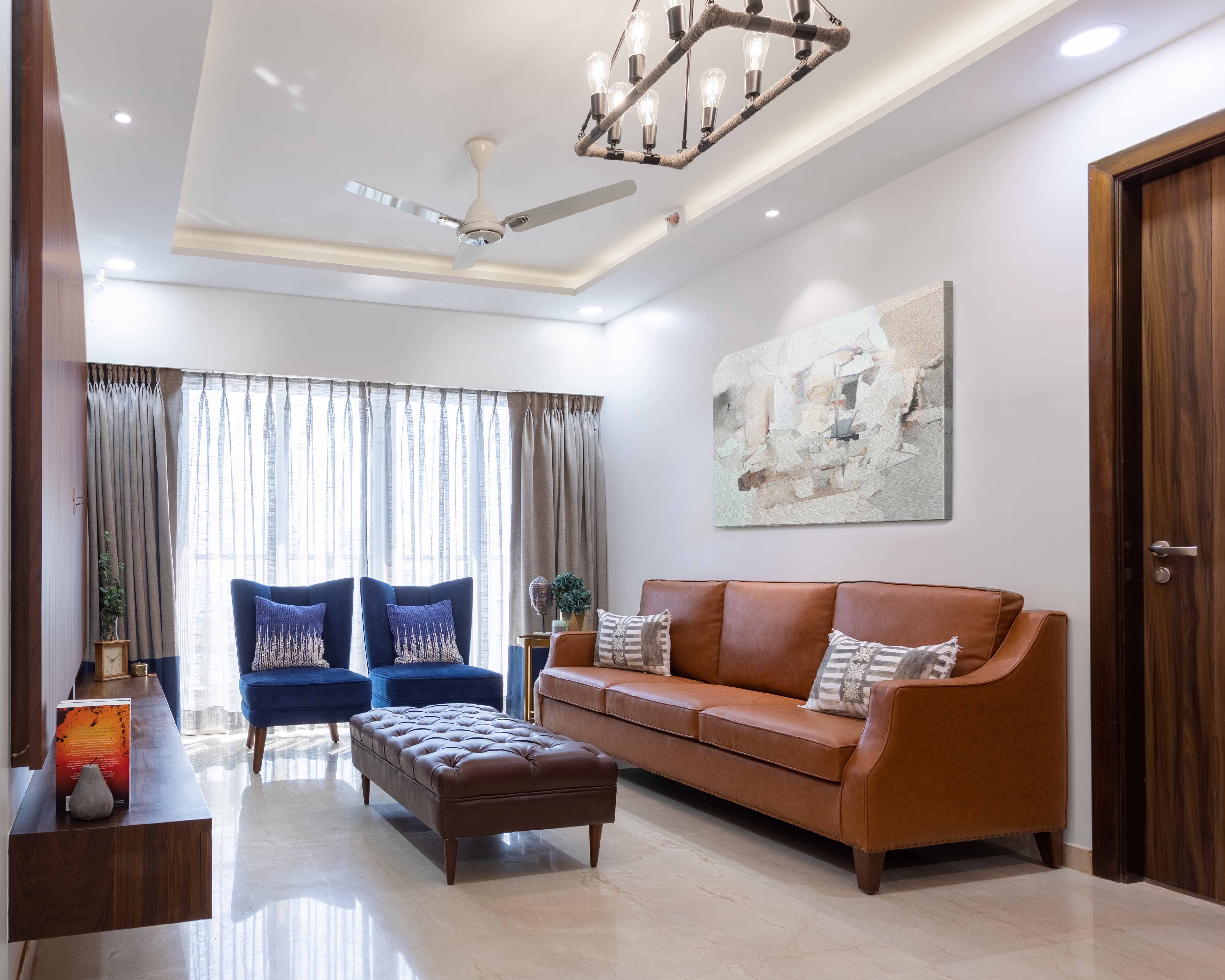 Contemporary Living Room Design With 3-Seater Brown Leather Sofa And Blue Accent Chairs