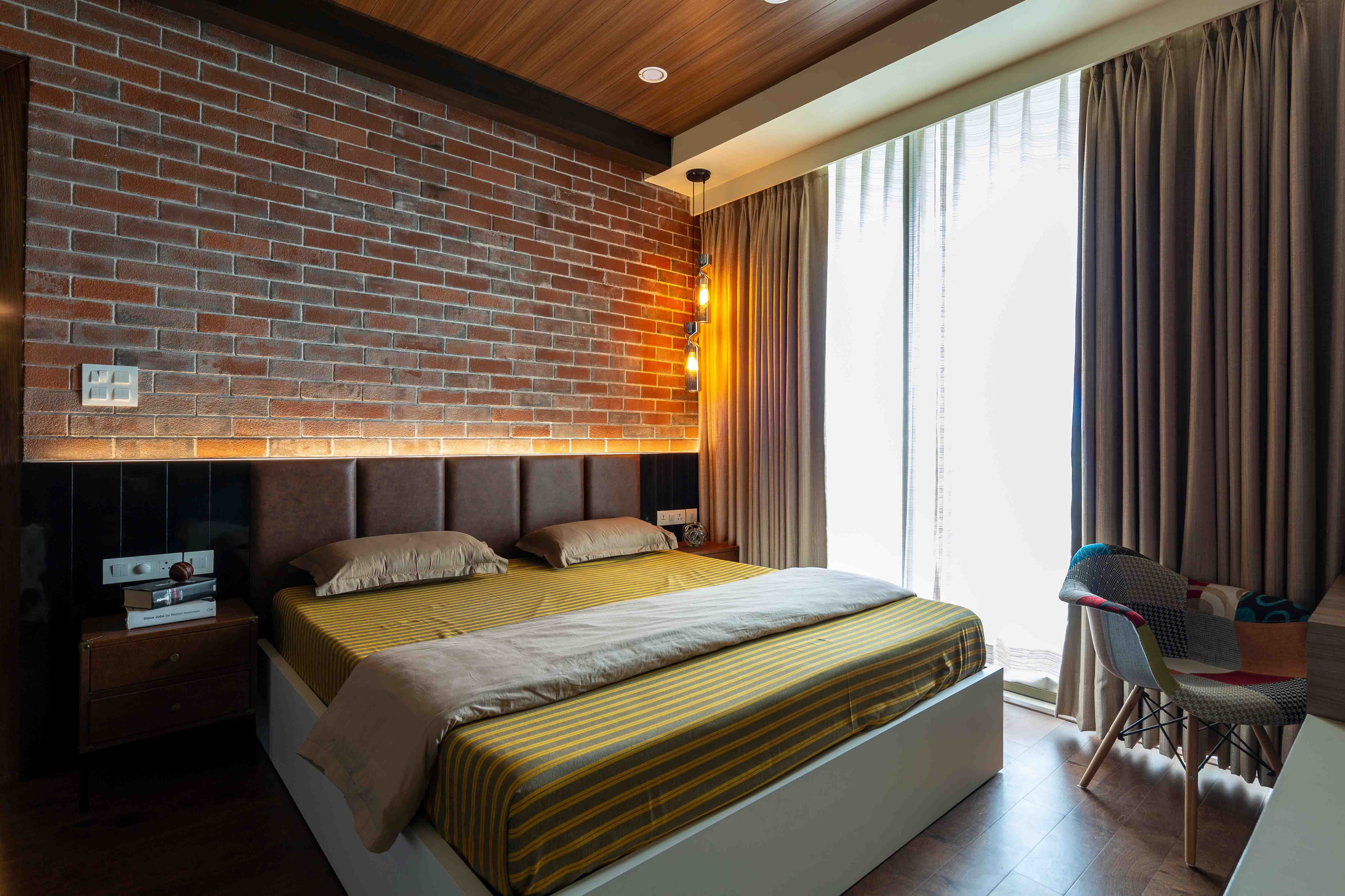 Contemporary Master Bedroom With Red Brick Accent Wall