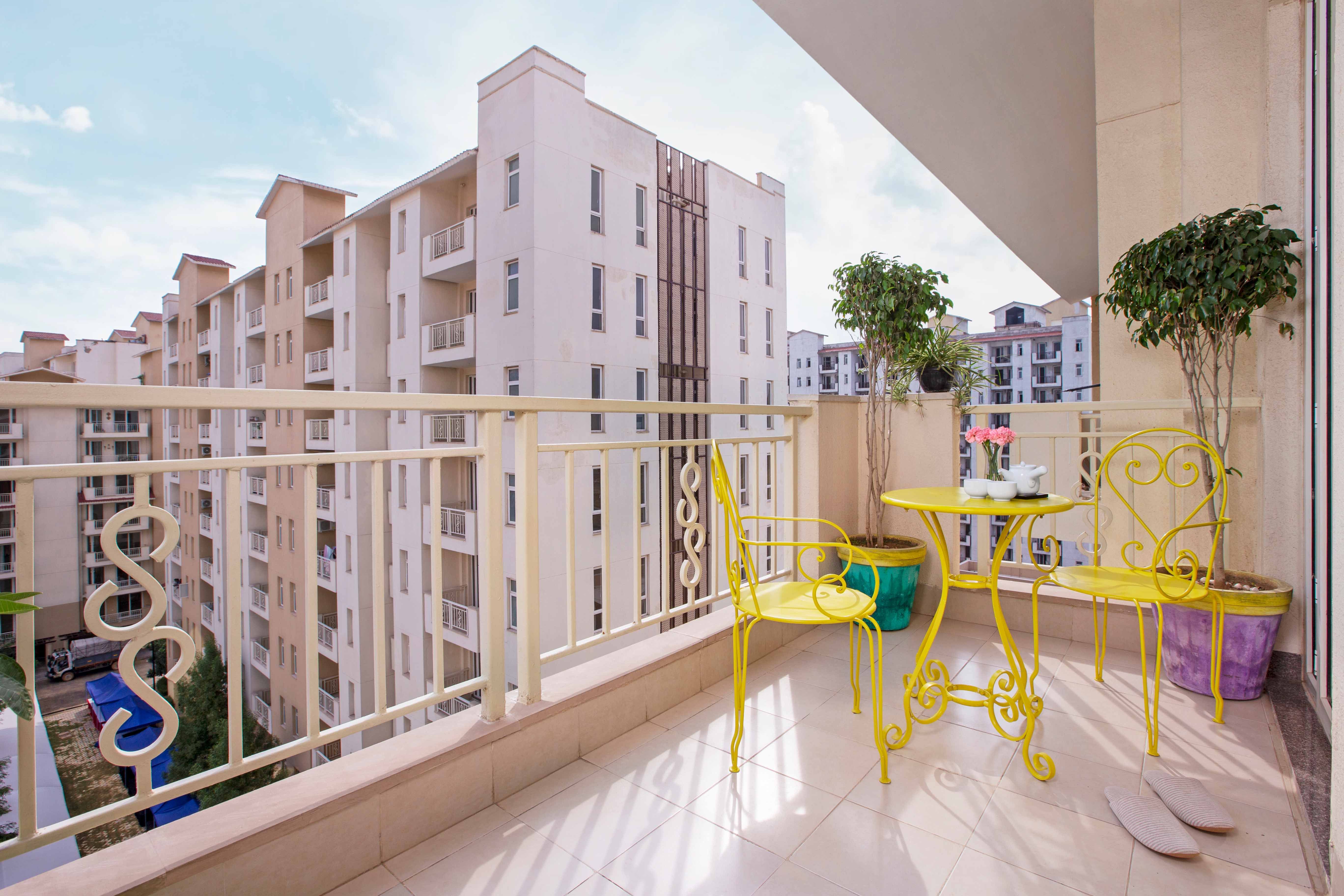 Modern Balcony Design With Bright Yellow Metal Table