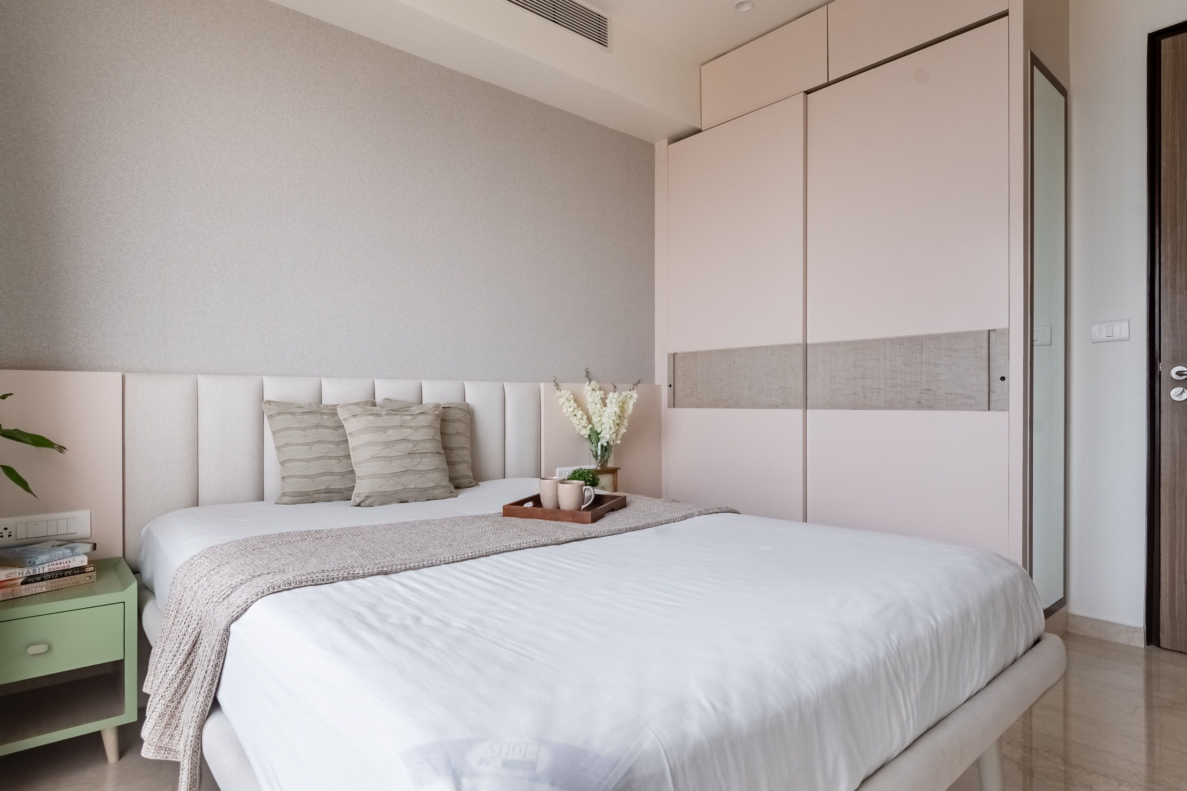 Modern Guest Room Design With Light Pink And Wood Sliding Wardrobe