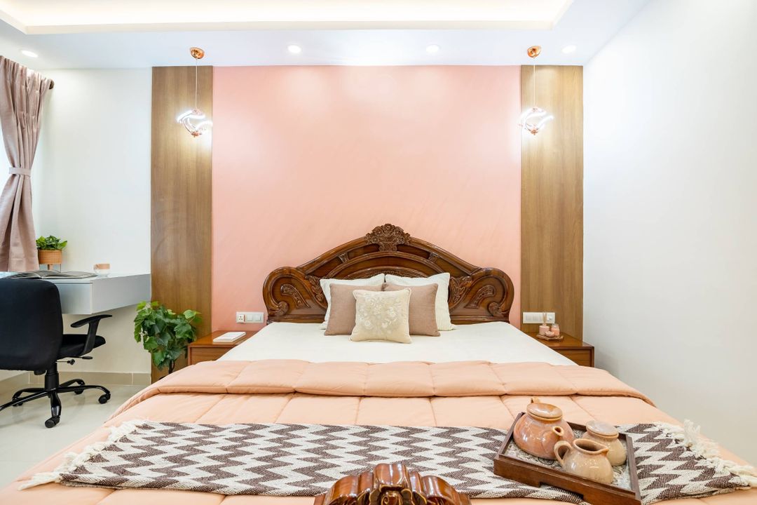 Spacious Bedroom Design With Pink Walls And Warm Hanging Lights | Livspace