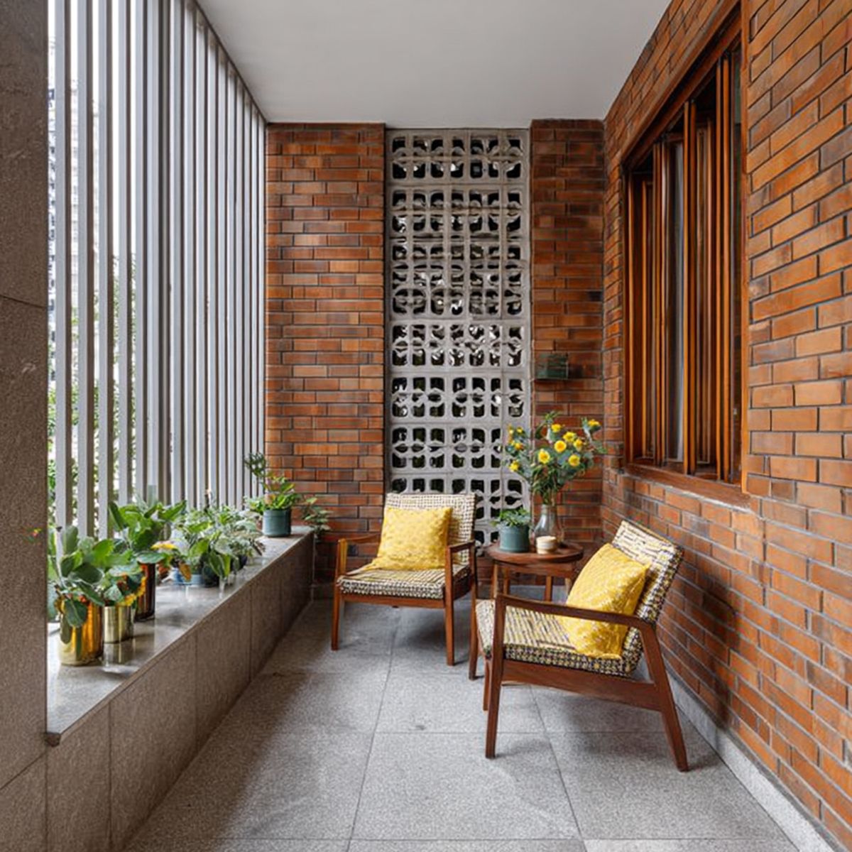 Industrial Balcony Design with Brick Wall and Concrete Flooring | Livspace