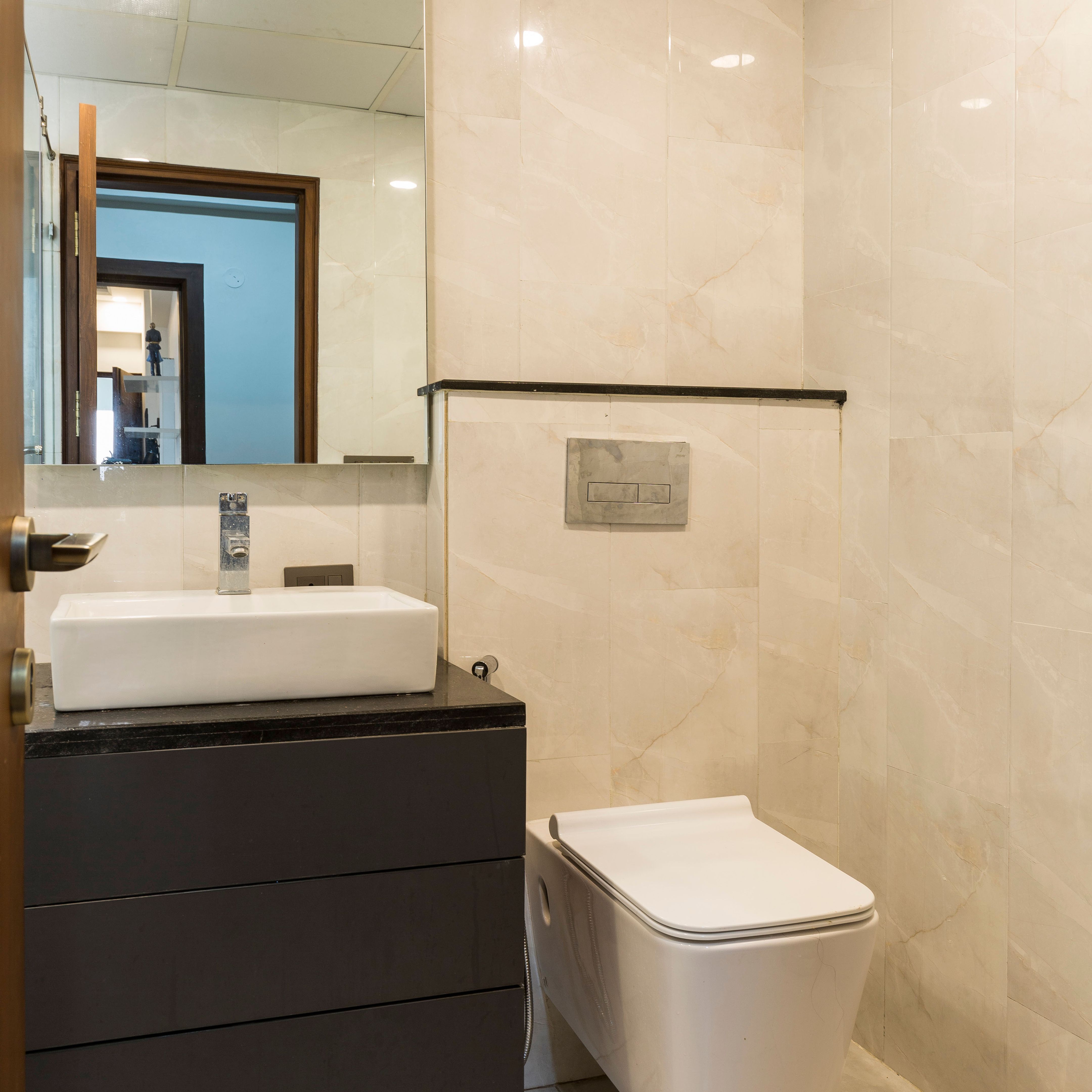 Low-Maintenance Small Bathroom Design Idea With Slate Laminates | Livspace