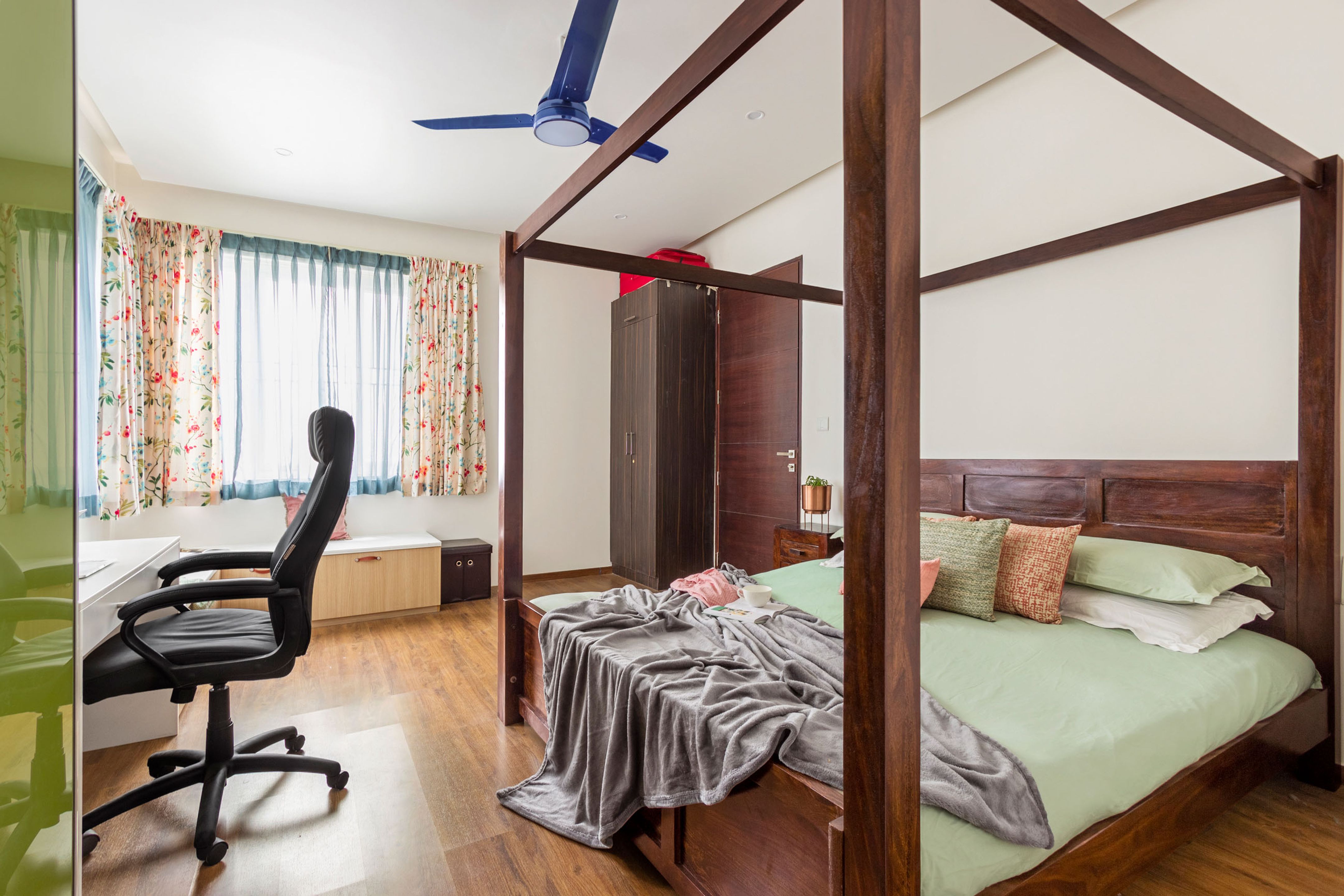 Master Bedroom With 4-Poster Wooden Bed And Green-White Sliding ...