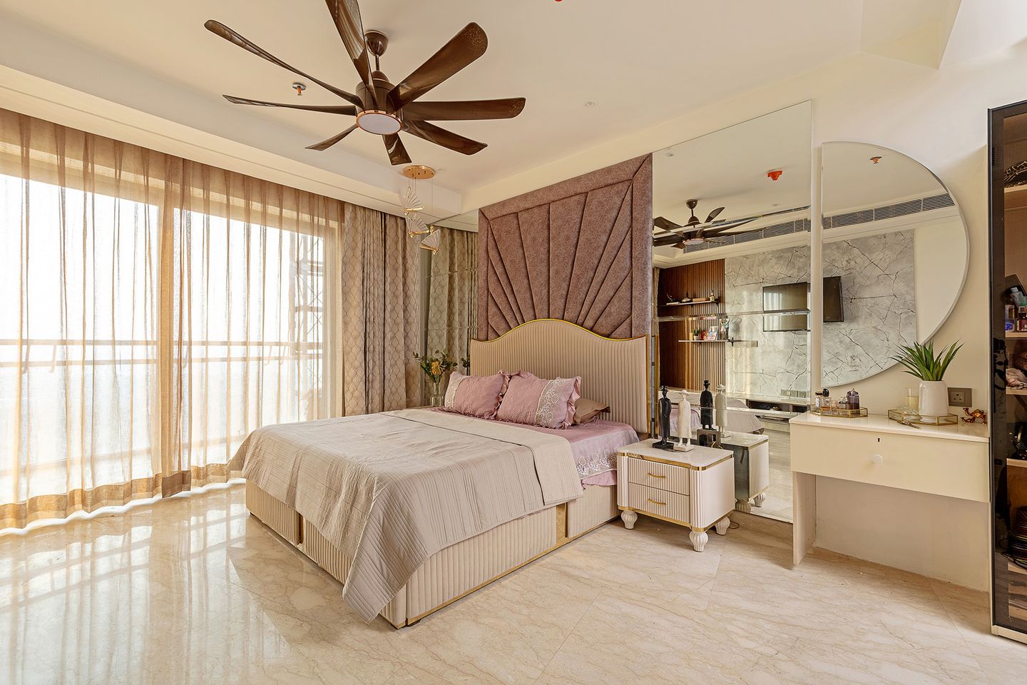 Bedroom Design with Tufted Headboard Wall and Crescent Mirror on Wall