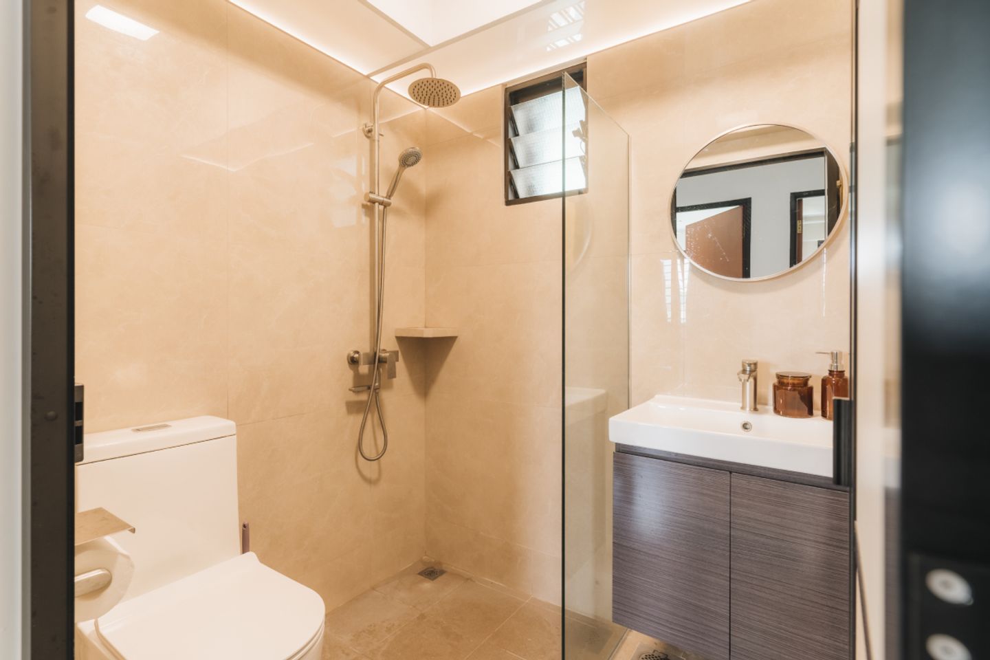Bathroom Design With A Round Mirror And A Shower Unit - Livspace