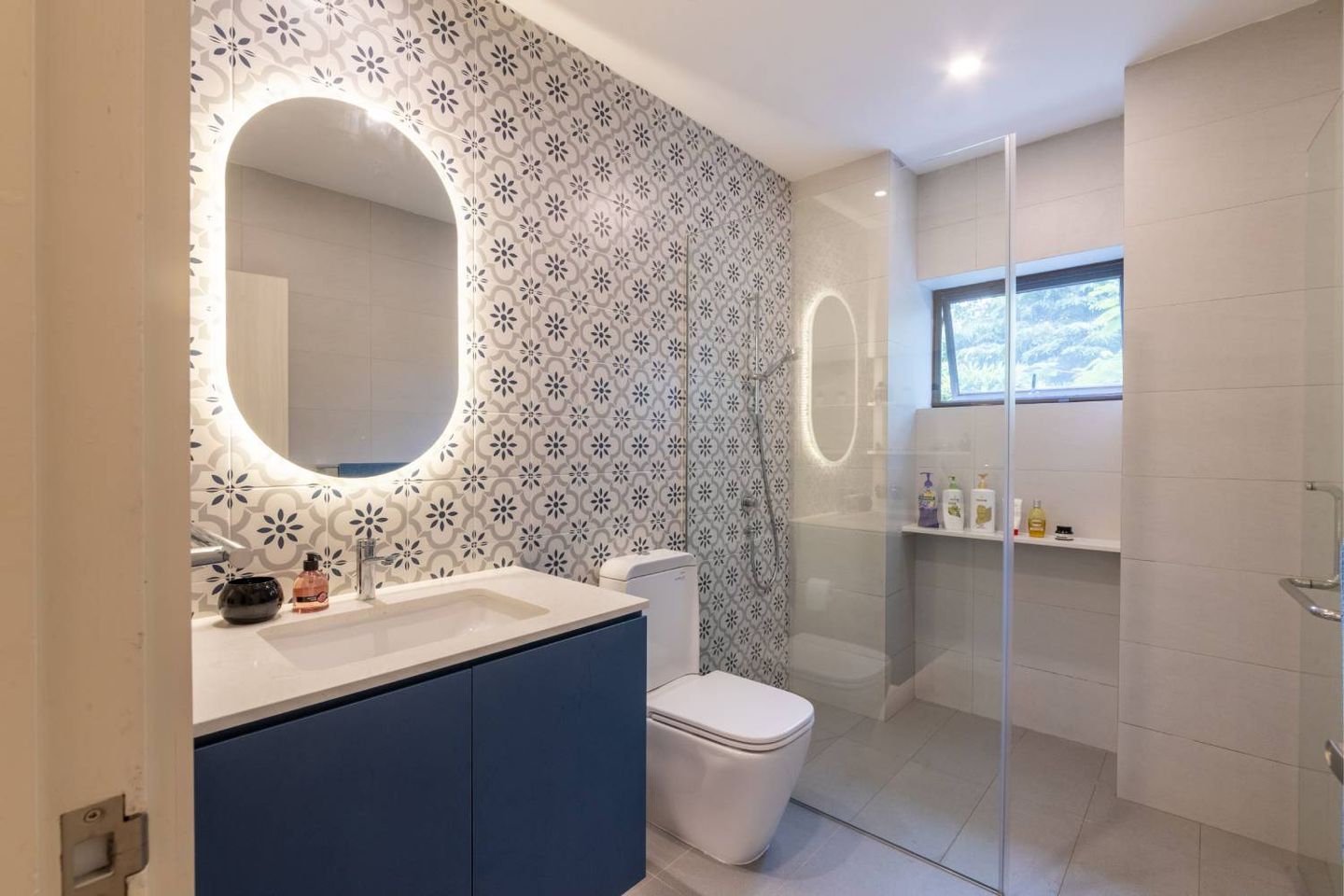 Light Grey Bathroom Design With Oval Mirror - Livspace
