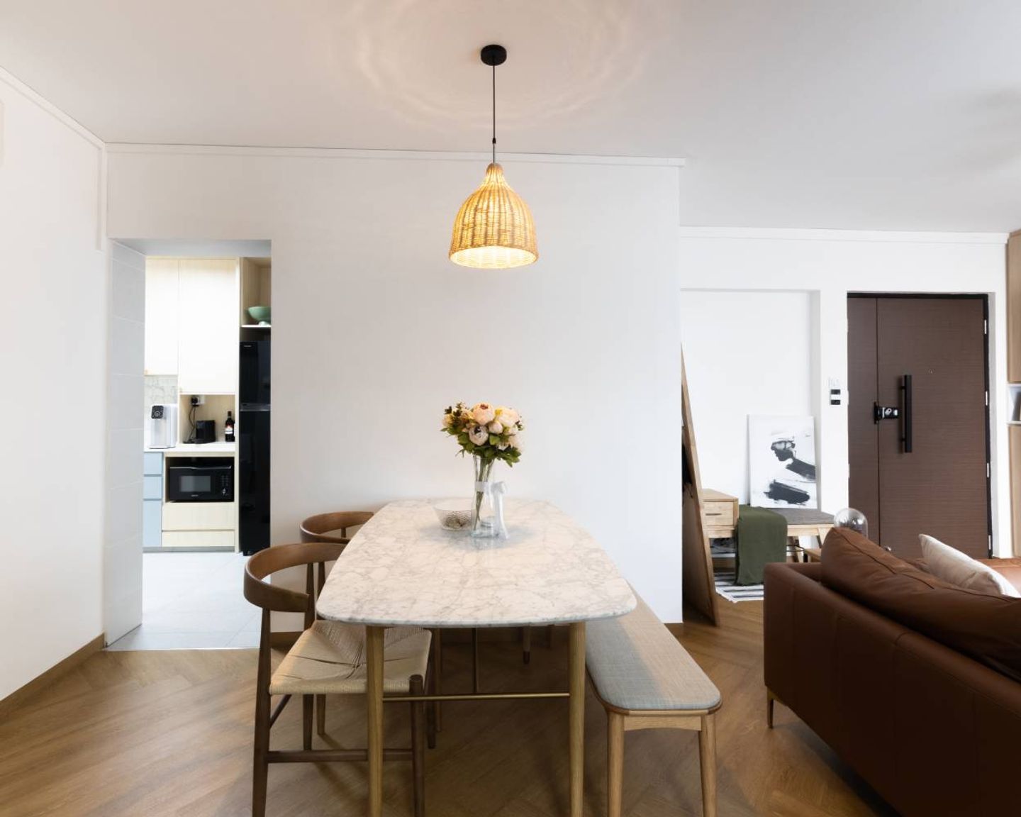 2-Seater Marble Dining Room Design With Rattan Chairs And Long Seater - Livspace
