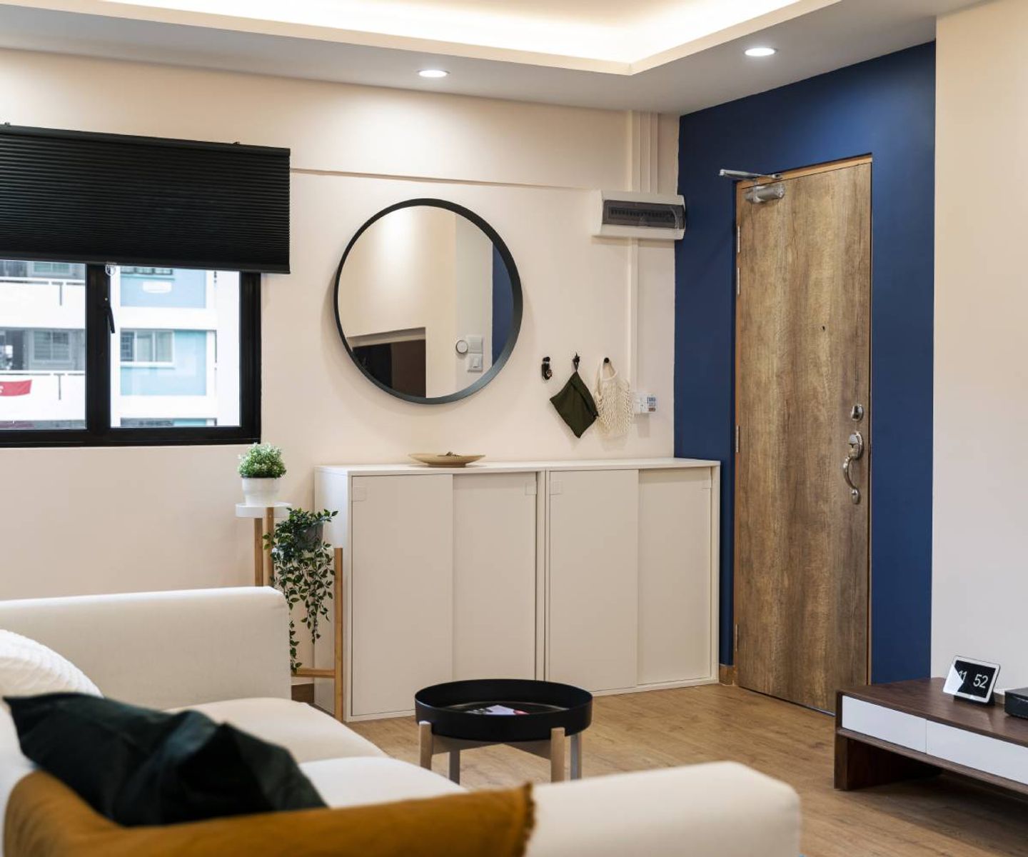 White And Navy Blue Foyer Design With White Sliding Door Storage Unit - Livspace
