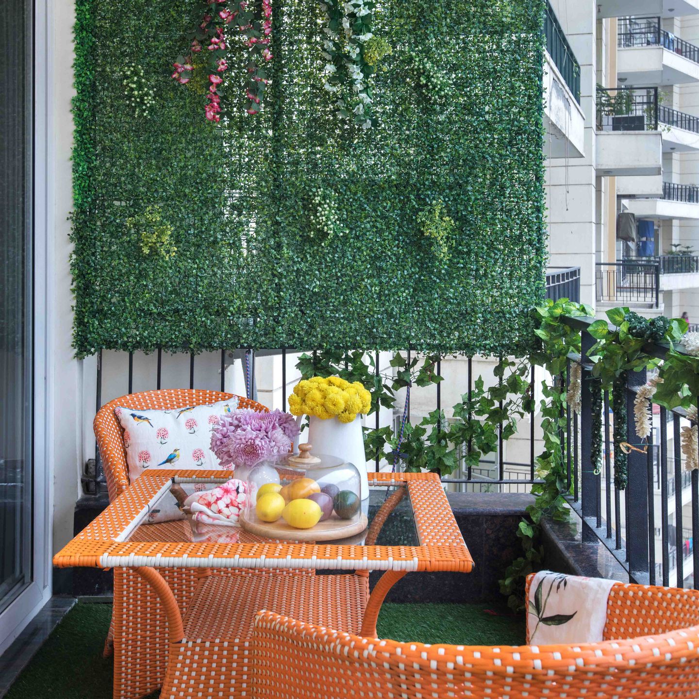 Contemporary Balcony Design with Grid Planter Wall and Vibrant Orange Furniture - Livspace