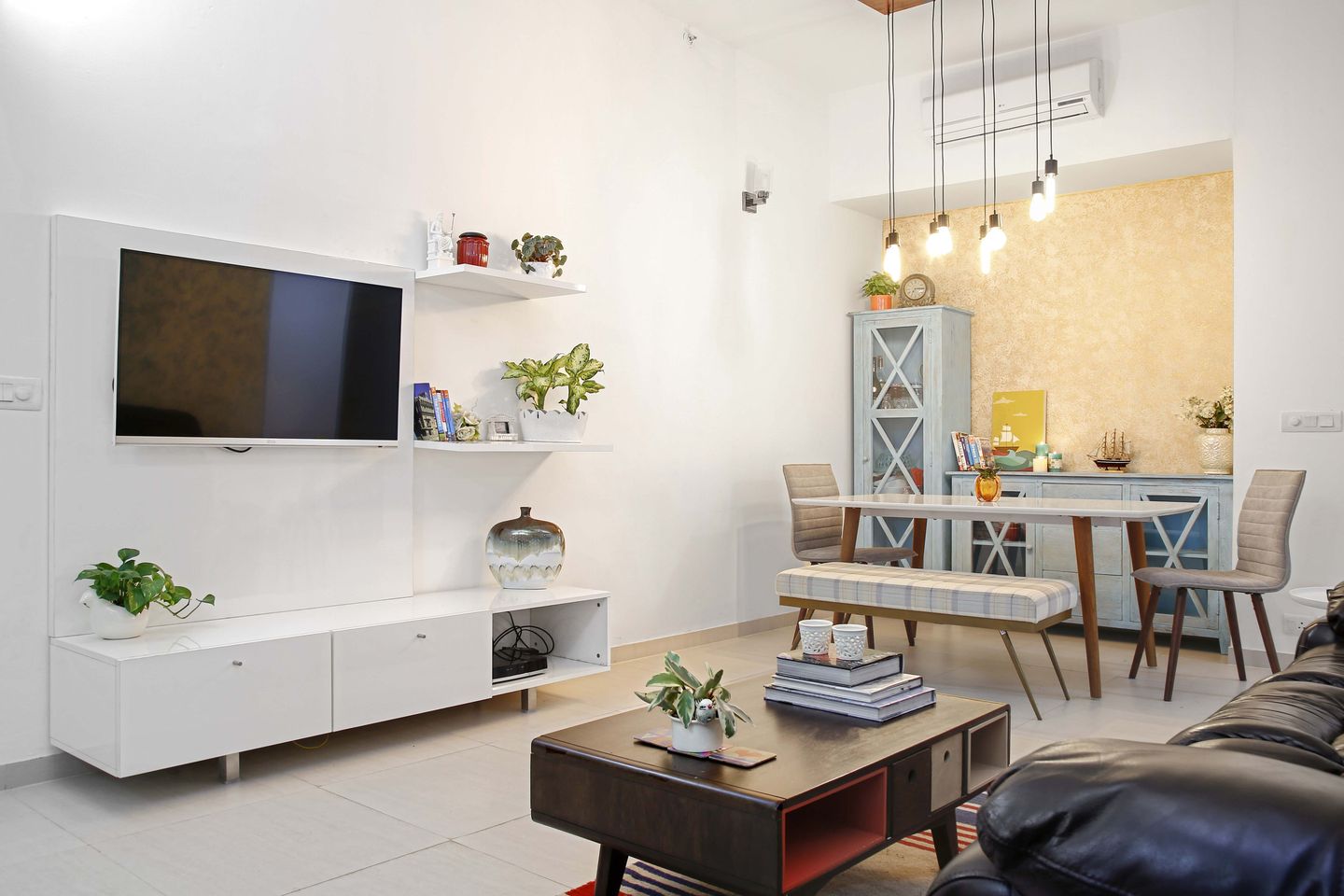 Spacious Living Room Cum Dining Room Design With White TV Unit - Livspace