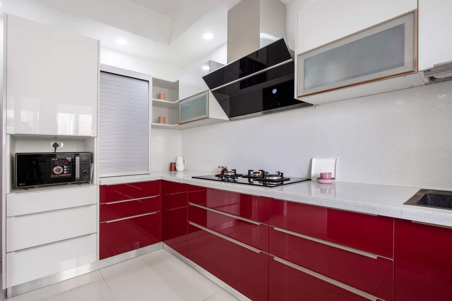Modular Red And White LShaped Kitchen Design With White Corian