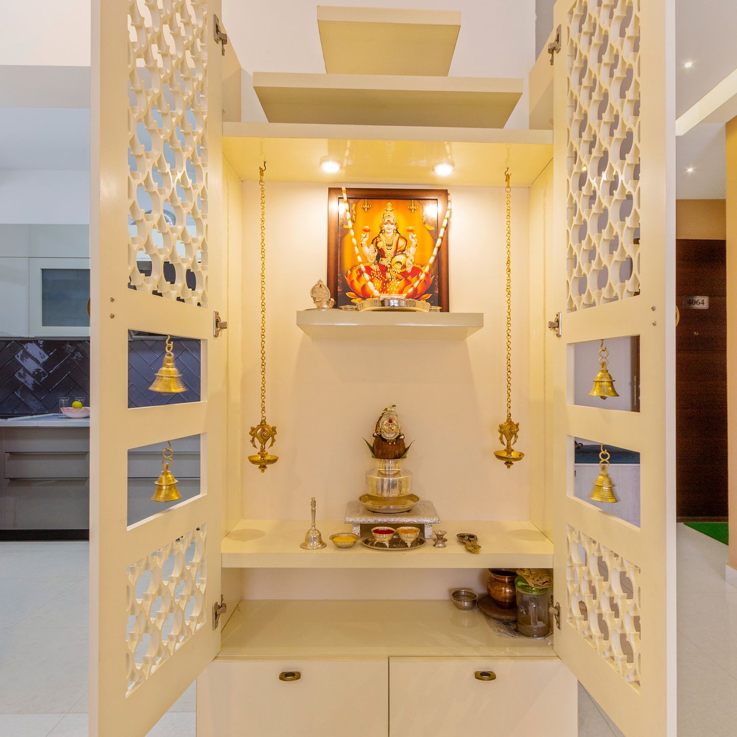 Frosty White Mandir Design With Perforated Door And Bells | Livspace