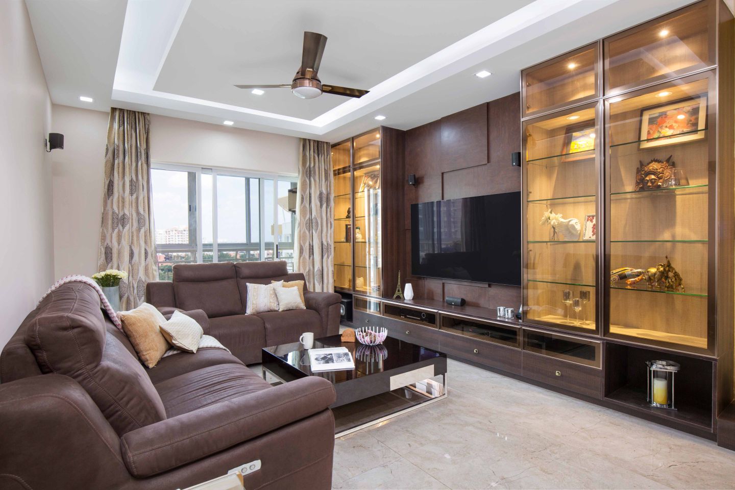 2-BHK Flat In Bangalore With Large Brown TV Cabinet Design And Glass Cabinet Storage - Livspace
