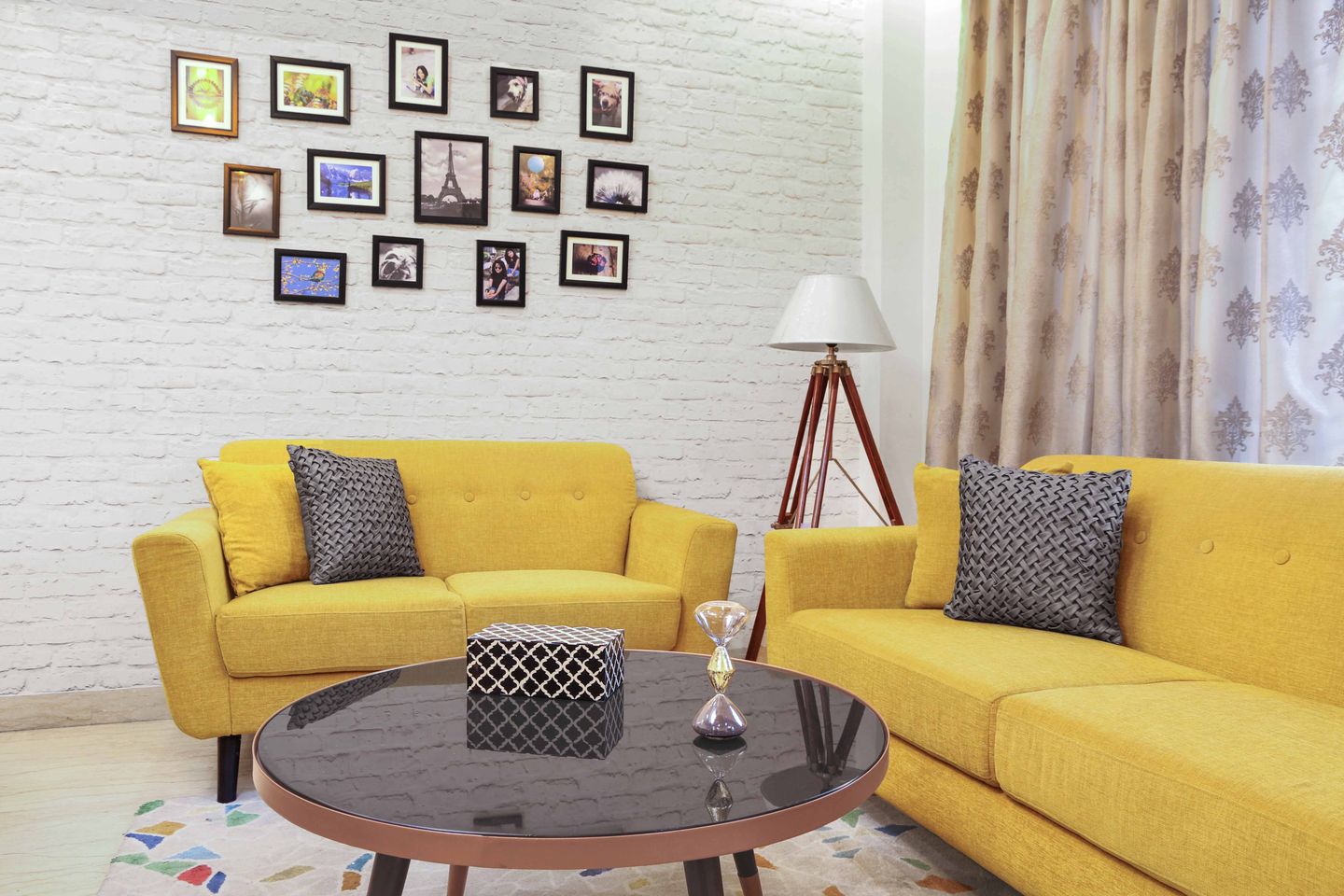 Living room with yellow sofa set and white brick wall - Livspace
