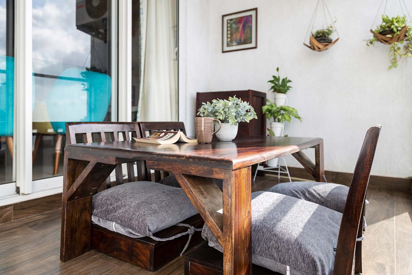 2-Seater Balcony Design With Wall Panters And Framed Wall Art - Livspace