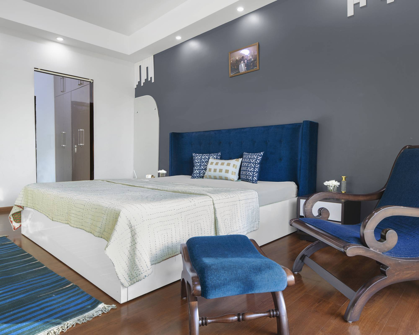 Modern Guest Room Design With Blue Accent Chair And Pouffe