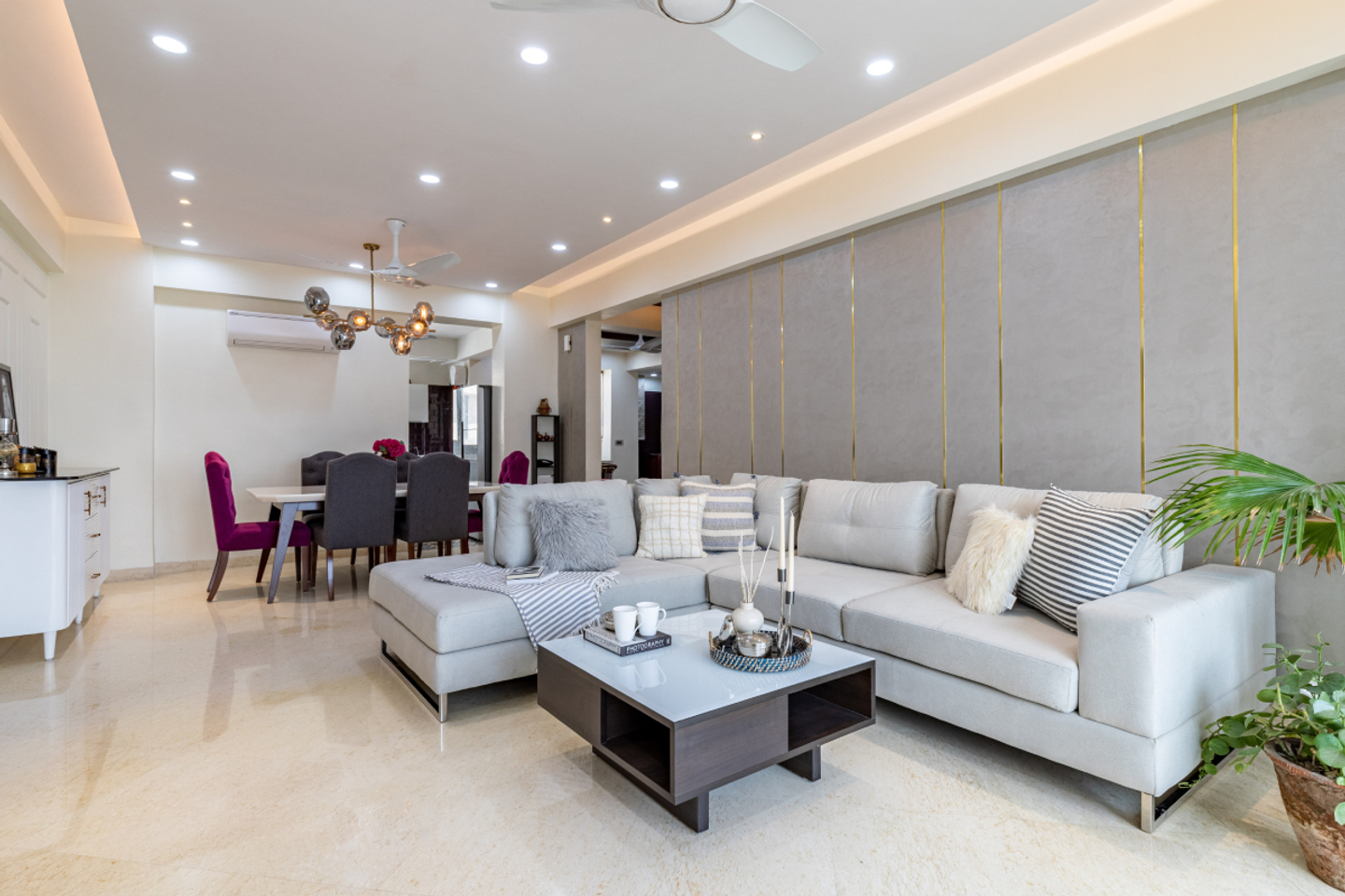 Living Room With A 4-Seater Grey Sofa And A Wooden Center Table With Marble Top - Livspace