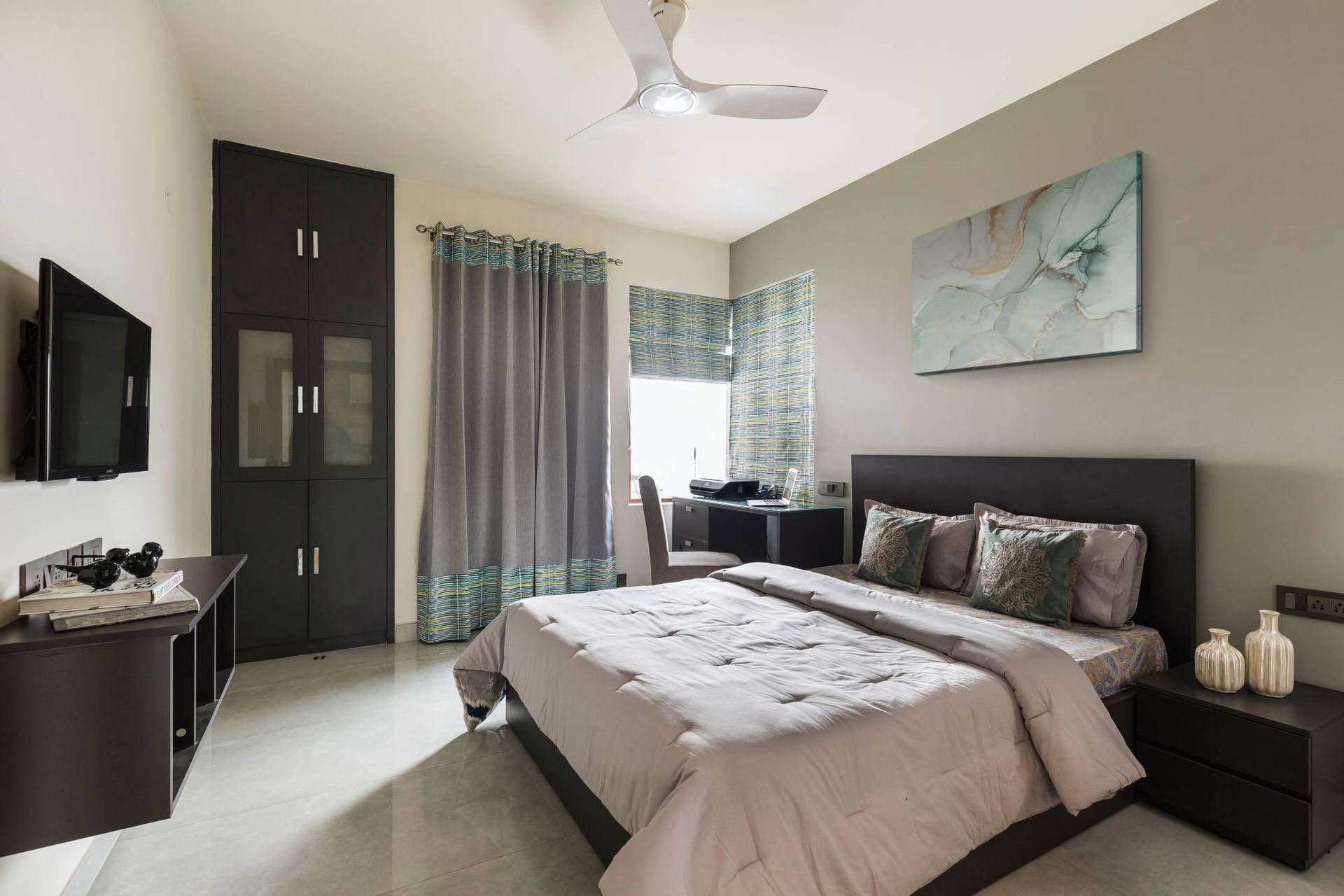 Spacious Guest Room Design With Dark Beige Accent Wall | Livspace