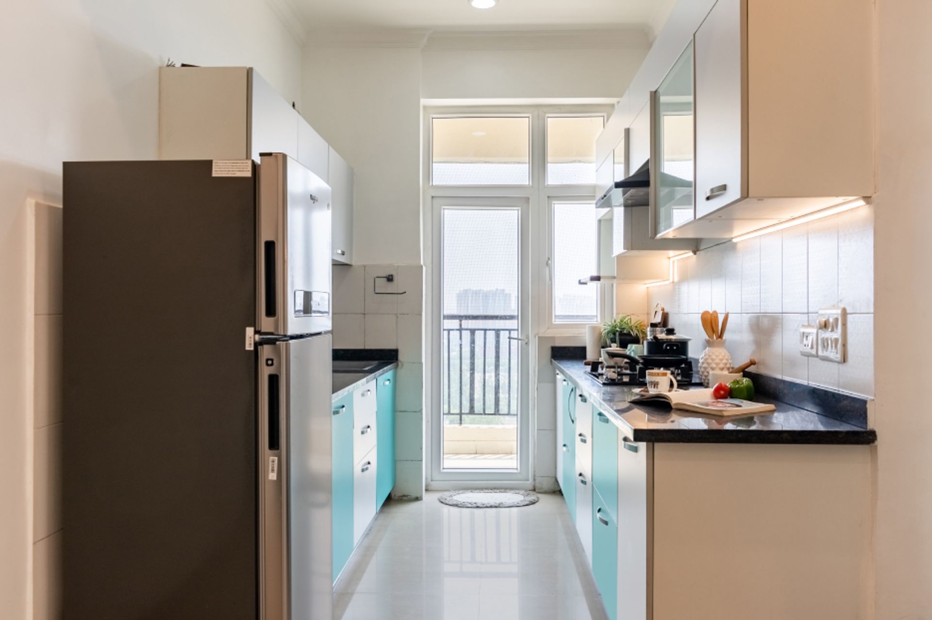 Compact Kitchen Design with Blue And White Storage Units | Livspace
