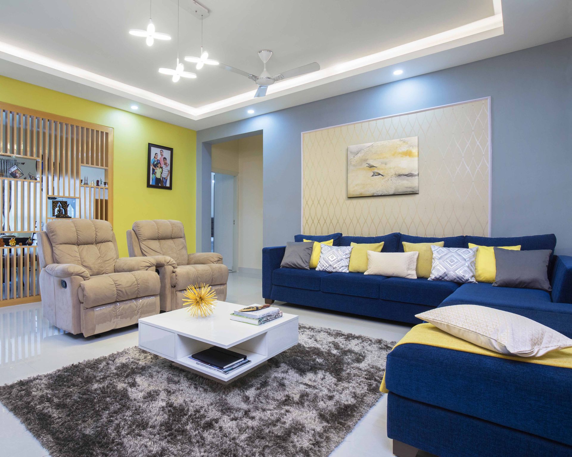 Spacious Living Room Design With Blue-Yellow Accent Walls And Dark Blue ...