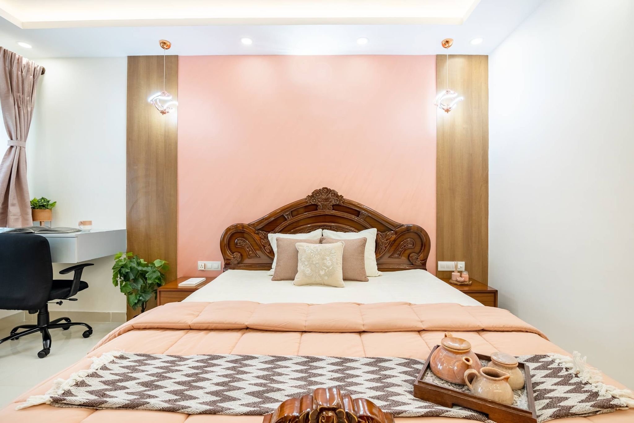 Spacious Bedroom Design With Pink Walls And Warm Hanging Lights | Livspace