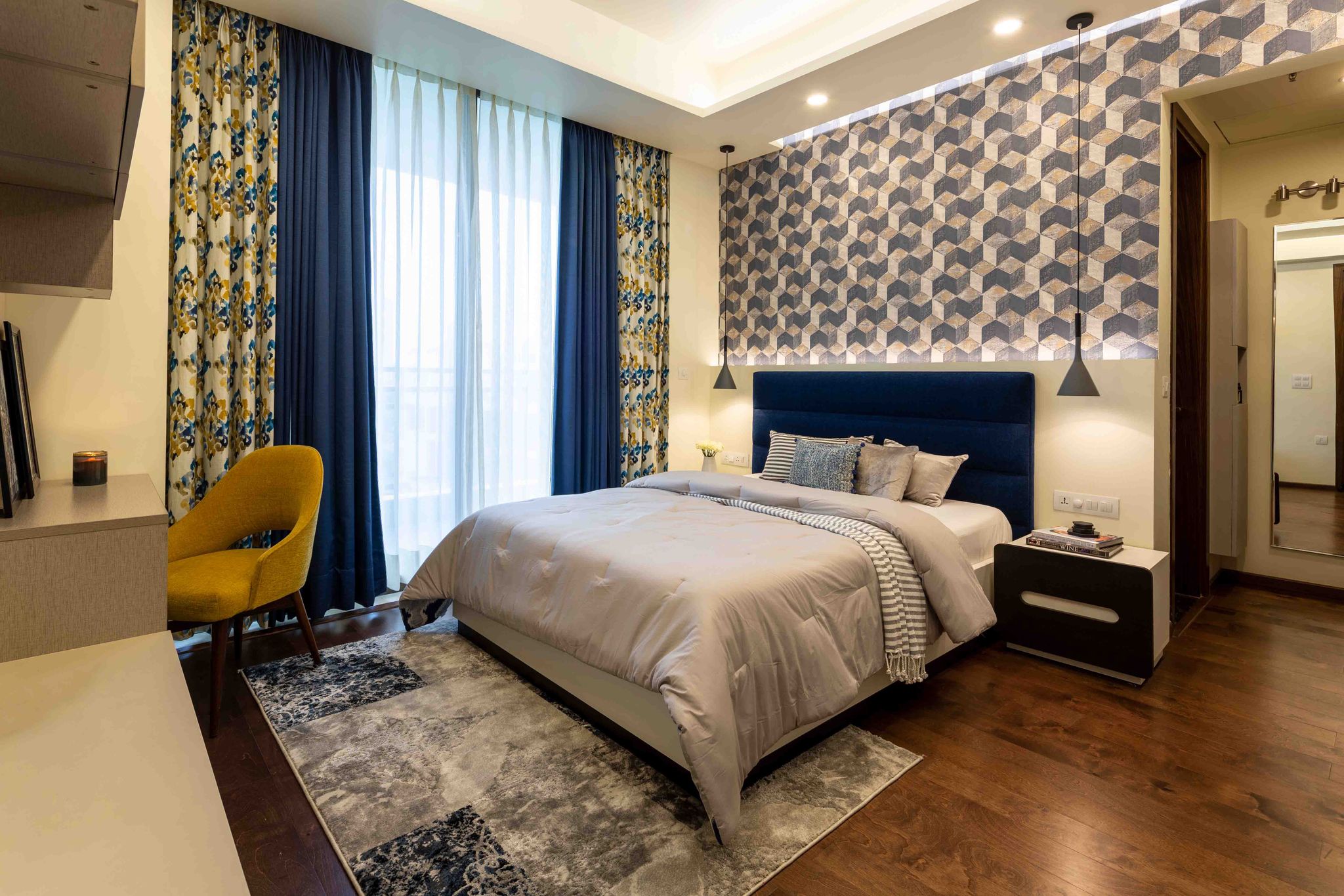 Contemporary Master Bedroom Design with Blue Tufted Headboard | Livspace