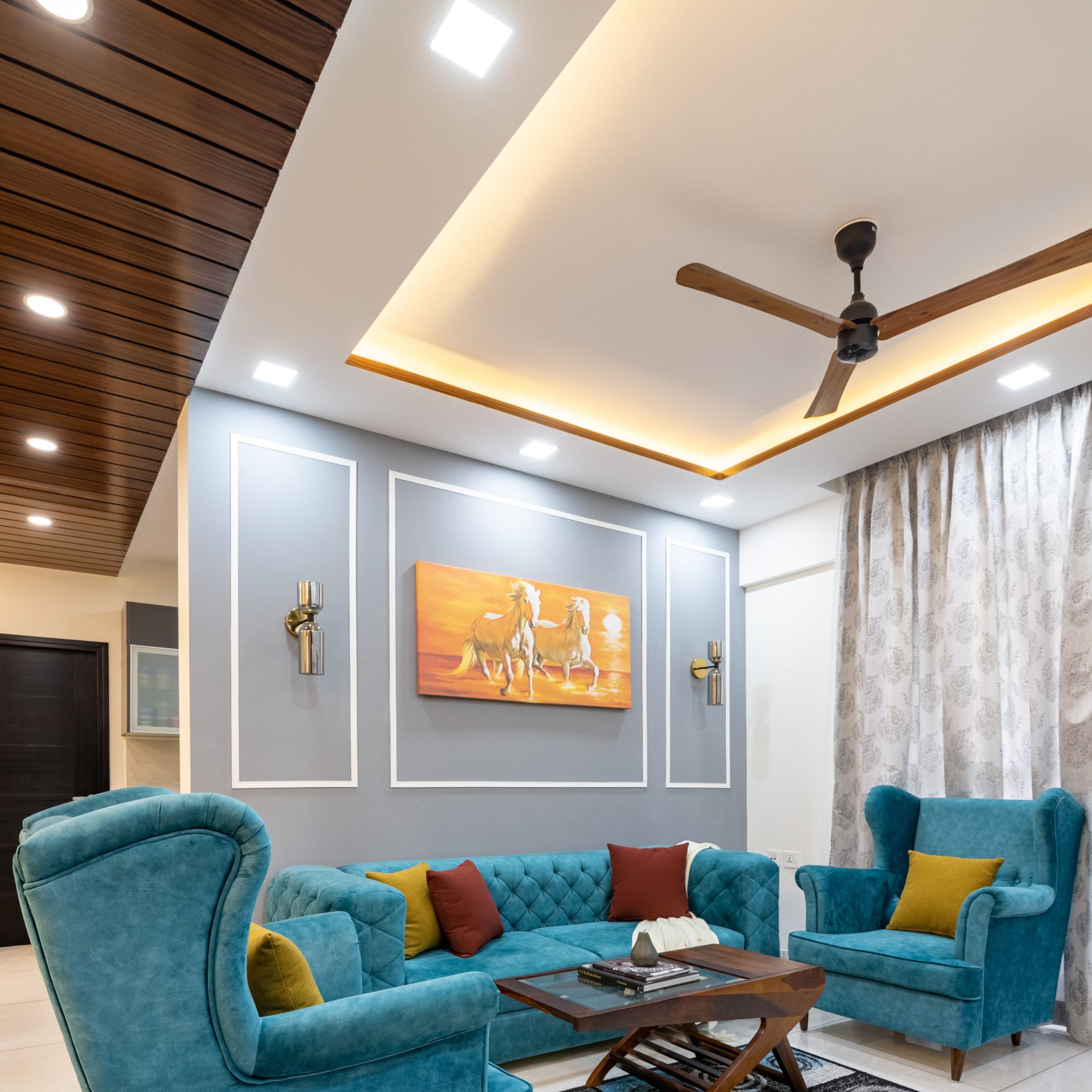 False Ceiling Design With Turquoise Couch - Livspace