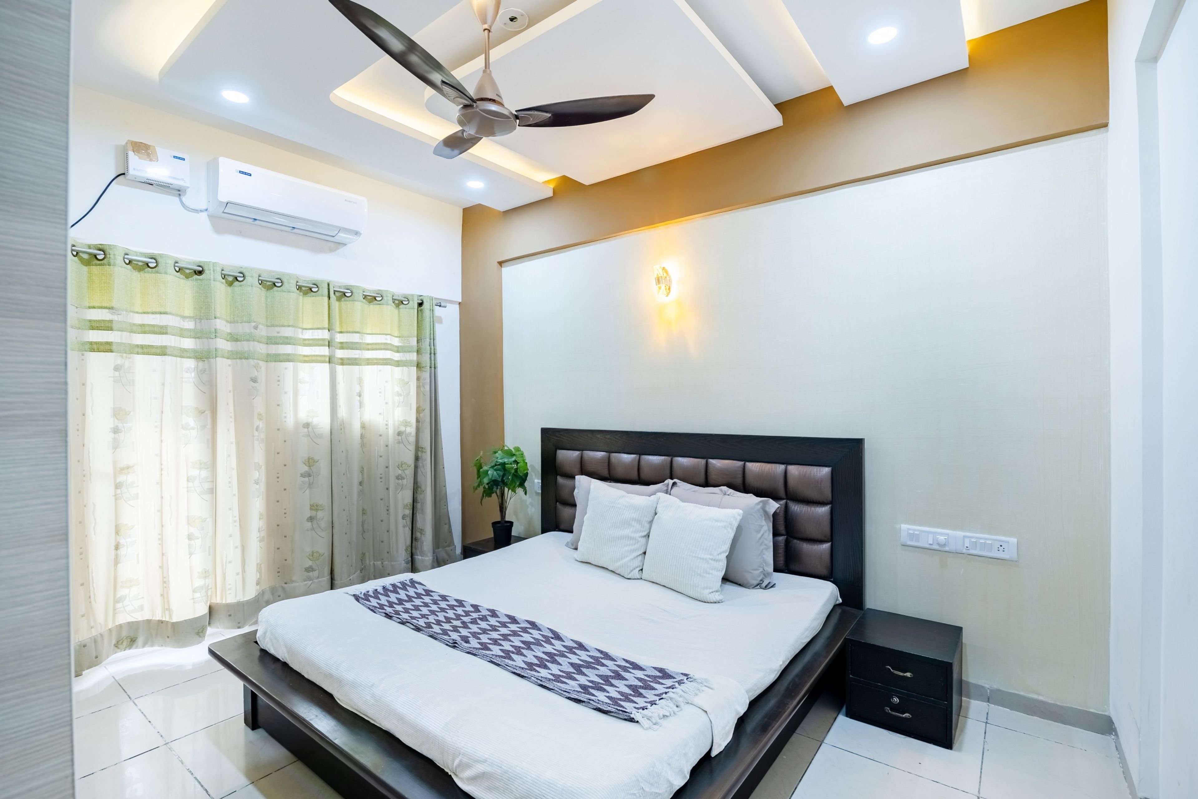 U-shaped false ceiling with warm lighting in a room - Livspace