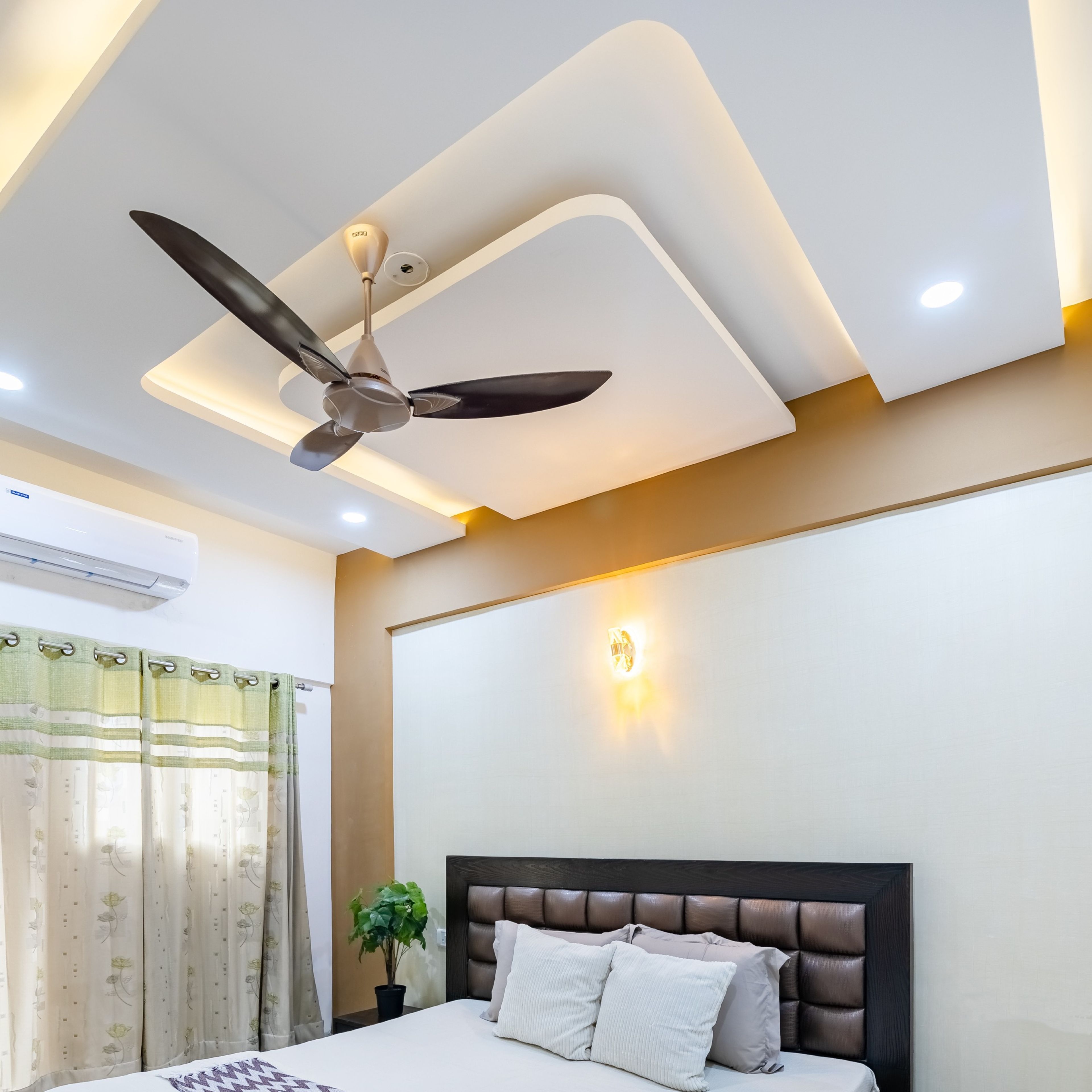 U-shaped false ceiling with warm lighting in a room - Livspace