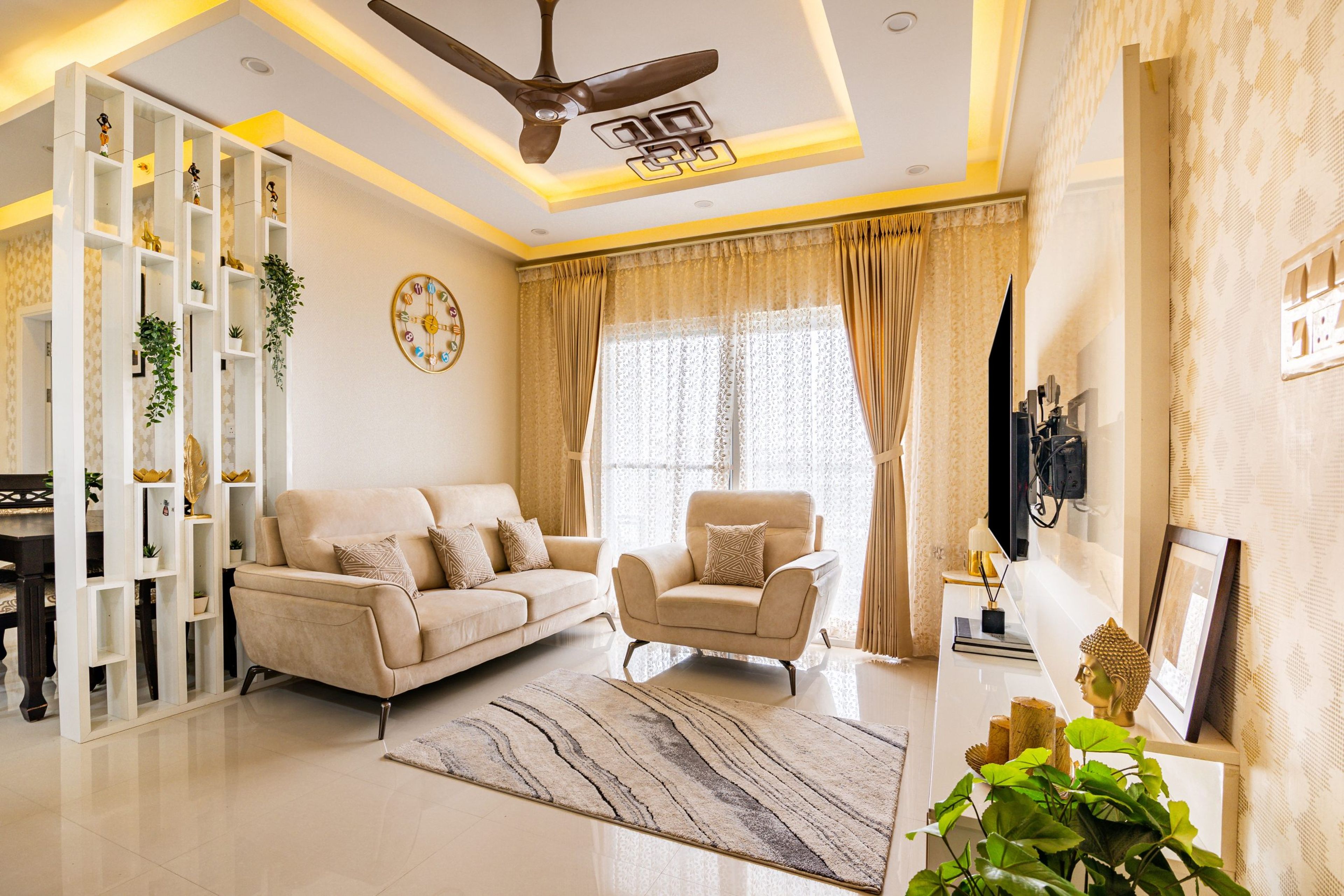 Peripheral ceiling design with warm strip lighting in a room - Livspace