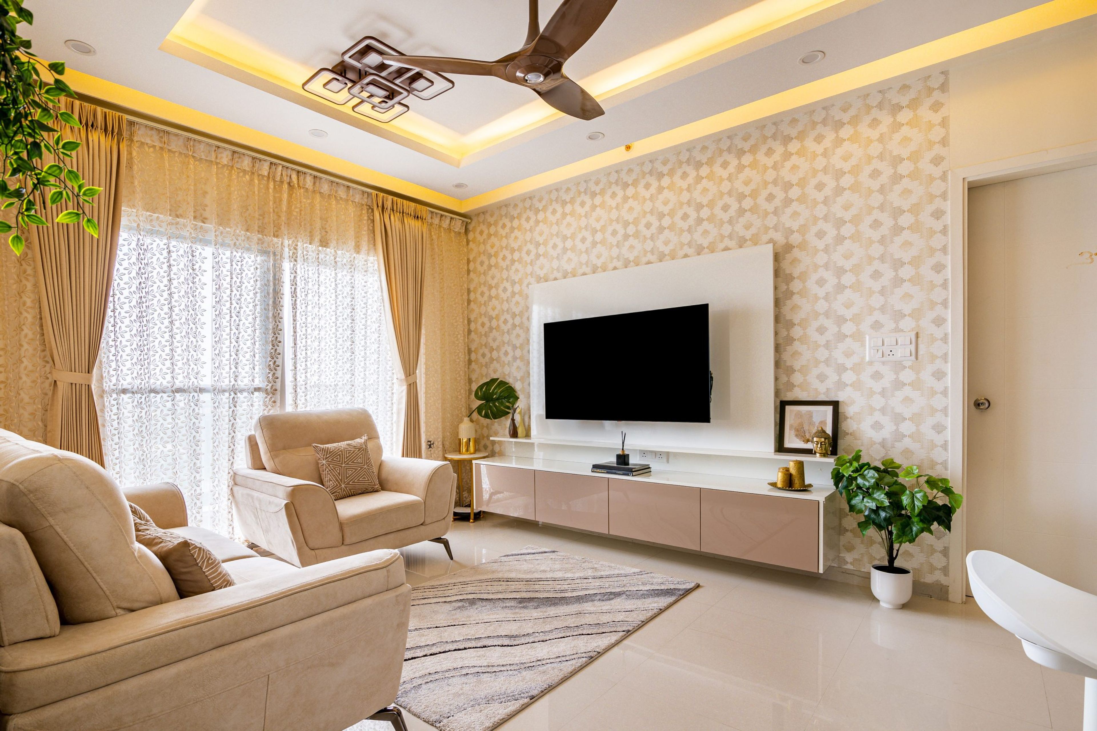 Peripheral ceiling design with warm strip lighting in a room - Livspace