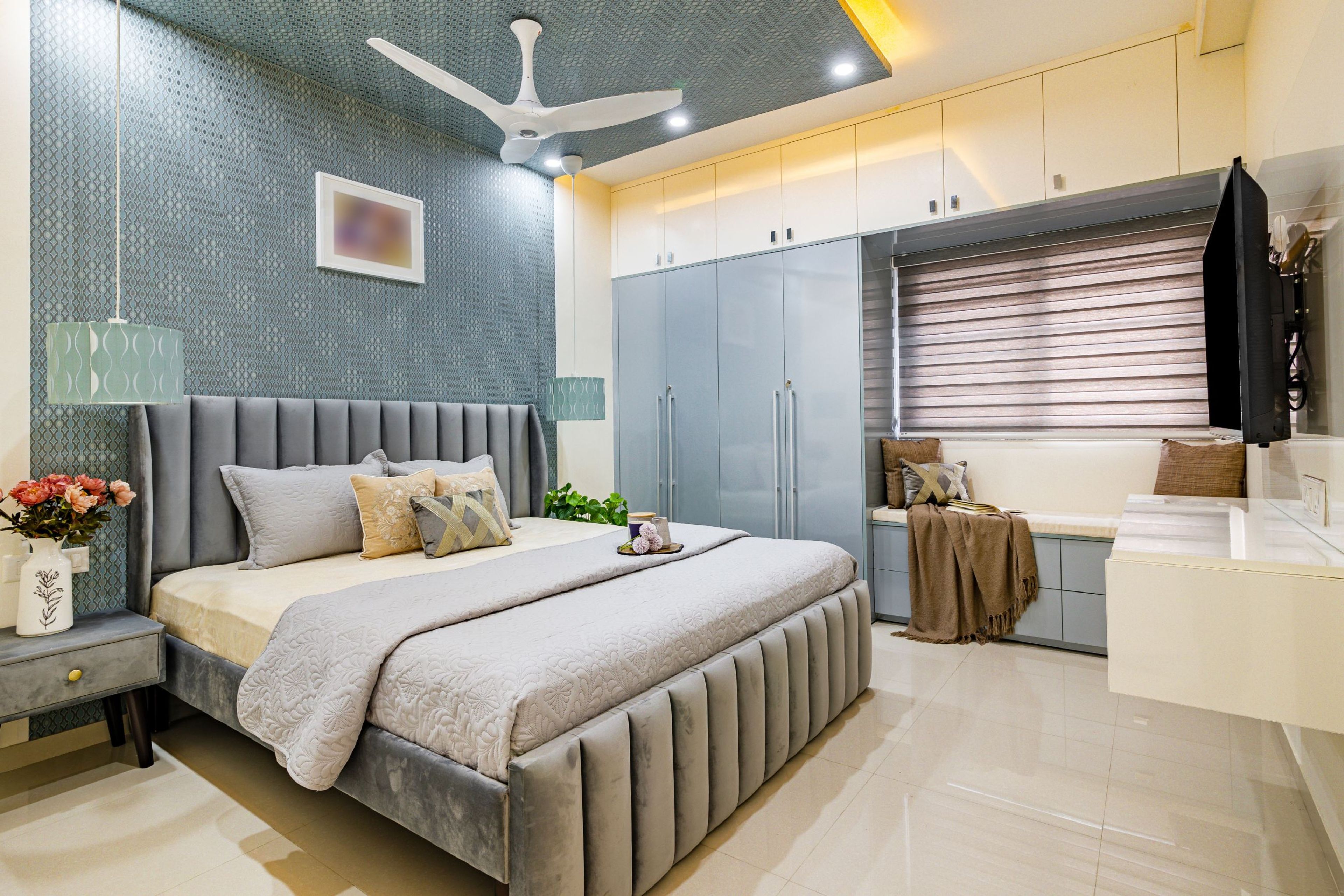 Gypsum false ceiling with warm cove lighting and pendant lights in a room - Livspace