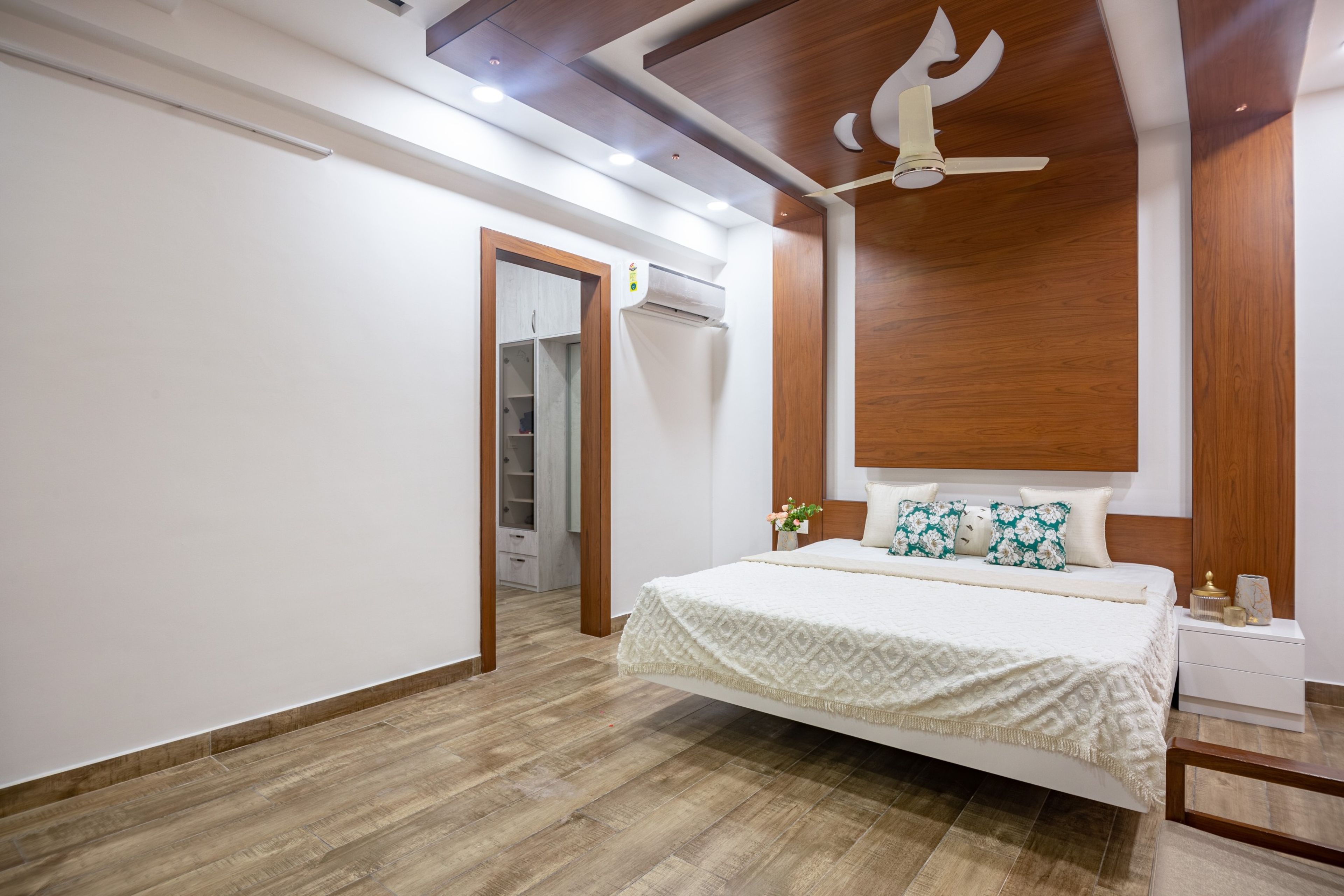 Wooden false ceiling with paneling in a room - Livspace